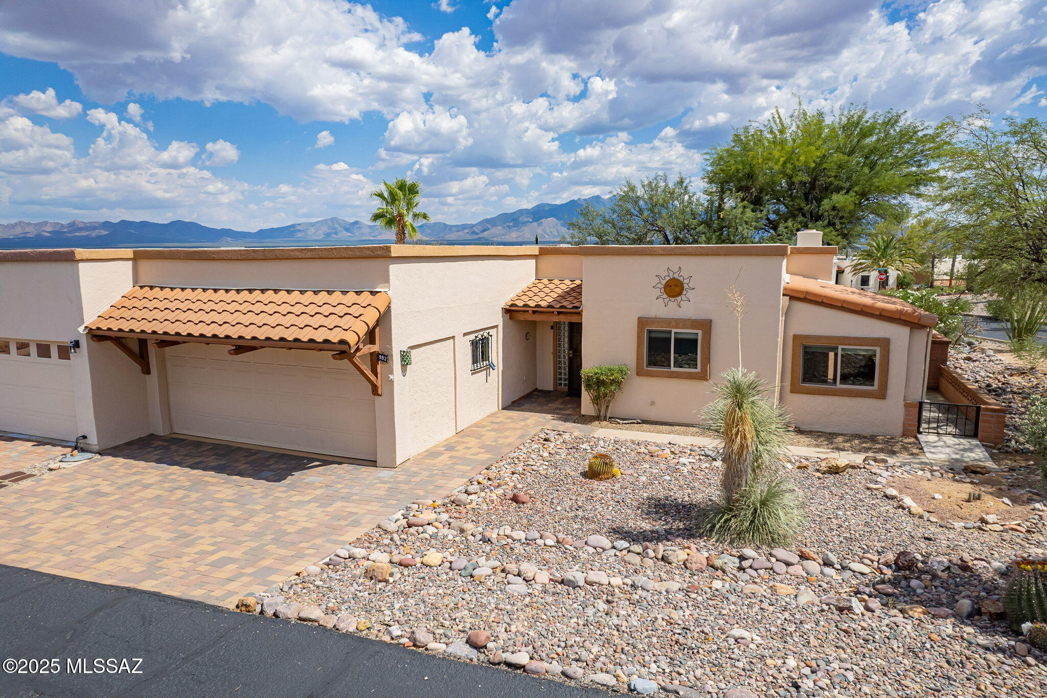 Very special home on a CORNER lot with spectacular panoramic mountain VIEWS  and outdoor living spaces!  Large  lot offers tons of privacy ! The sprawling back patio is magnificent. Offering lots of options for different seating areas, this  will be your favorite place to entertain family and friends. The mountains and wide open desert sky are the backdrop and a gurgling fountain offers ambience. Inside, spacious rooms and lots of natural light give the home a fresh and airy feel. A beautifully remodeled kitchen features light maple cabinetry, granite counters and gleaming stainless appliances.  A buffet with built in wine bar adds more prep and storage space.  The dining room is open to the kitchen and offers a built in buffet for showing off special dishes or art pieces. The natural light in this room will invite guests to linger. The living area is anchored with a floor to ceiling birick and stucco beehive fireplace and sliders leading out to that gorgeous patio. Your primary suite is perfect with windows and plantation shutters framing the views. A remodeled bath features a new vanity and tiled walk in shower. The guest suite doubles as an office or den and boasts a custom maple murphy bed for winter guests. With its views, upgrades and central location close to recreation centers, restaurants and the farmers market, there is nothing left to add to make this home perfect!