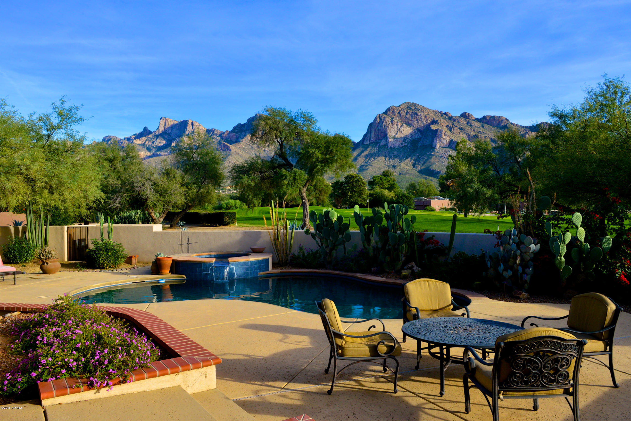 Opportunity Knocks! Custom home built in 2004 on premium golf course lot in the exclusive 3rd Fairway of OVCC! 3134sf with east-facing backyard Pusch Ridge views and sits adjacent to the 3rd green. Pebble tec pool & spa, 1500+ sf of covered patio with outdoor fireplace. Spacious kitchen with granite counters, butcher block island, hi-end SS appls and alder cabinets. Great room has wood beam ceiling and wall of windows to capture pool & mountain views. Split floor plan w/private master suite, den(or 4th BR) and 3/4 powder bath on one side of home; 2 BRs and jack-n-jill bath on the other. Paver/circle drive & 3.5+ car garage, private carts ok at OVCC. Fabulous home for those who want luxury desert living & country club lifestyle. Seller will pay one-time initiation fee for buyer membership!