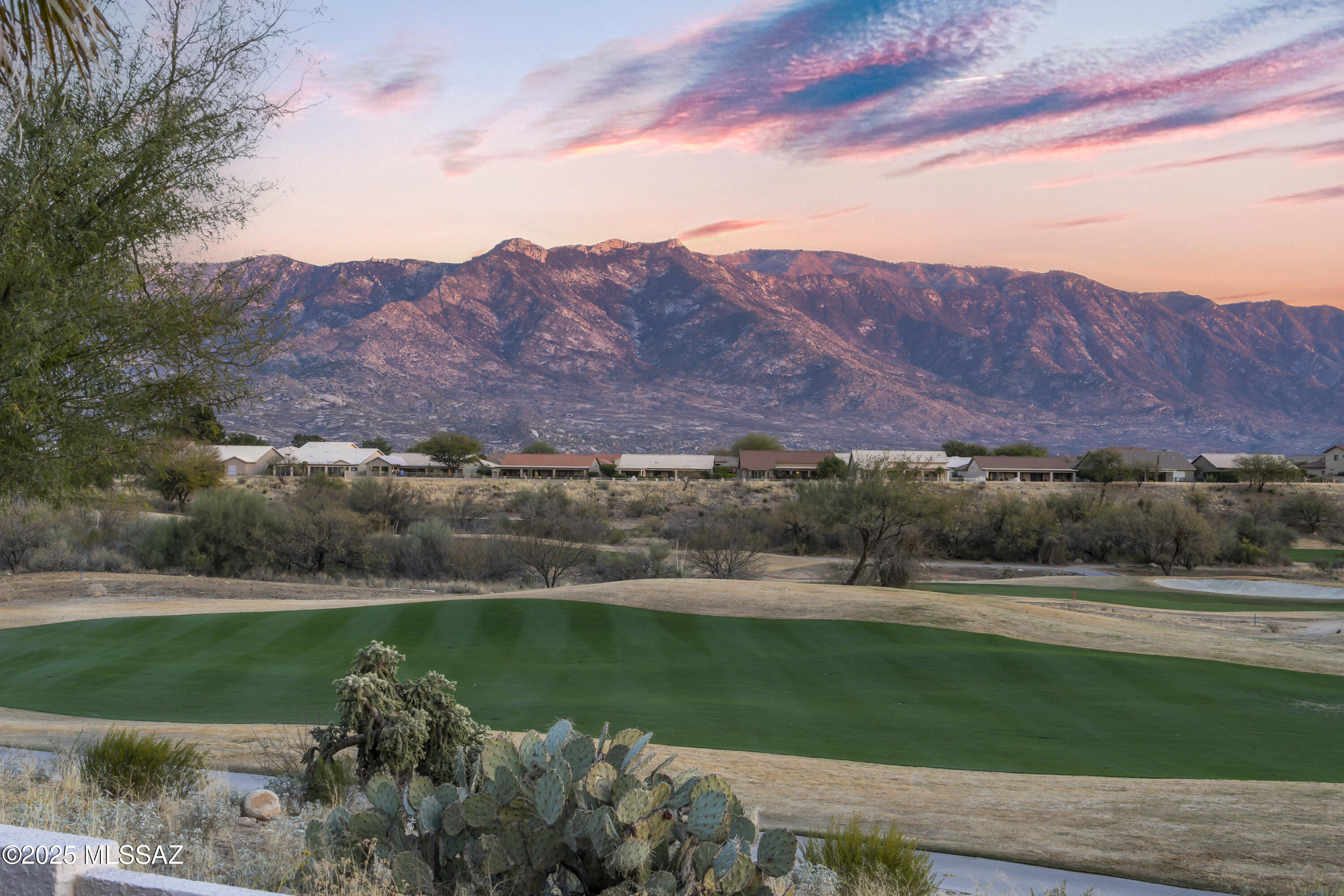 Stunning golf course home on an elevated lot showcasing breathtaking Catalina Mountain Views. Sited perfectly to view holes 1,2, and 3 on the recently renovated Mountain View Golf Course. Immediately upon entering through the beveled front glass doors, you will be welcomed to all the quality features and finishes in the home: wood flooring throughout living room and dining room and a gorgeous wood and tile circular staircase with a wrought iron railing. This is the ideal home for entertaining with its large kitchen featuring cherry finished cabinets, appliance garage, granite countertops, glass tiled backsplash, coveted gas cooktop, dual ovens, and an abundance of storage including the charming etched glass pantry doors.  Kitchen opens effortlessly to the family room which also showcases spectacular mountain and golf course views with no pillars to obstruct the view. Step outside the kitchen nook onto your expansive paver patio with retractable screens and enjoy your morning coffee or adult beverage or favorite book. Primary suite features a large bedroom and the bath features dual sinks, a corner jetted soaking tub and ceramic tiled shower with 2 large walk in closets. This is a great place to wind down after the days activities are complete.  Also on the main level is den/office/hobby room. Upstairs is ideal for guests with 2 generous size bedrooms with a Jack and Jill bath, and a built in queen size murphy bed. Discover the perfect blend of comfort, luxury, and community in this exceptional SaddleBrooke home well maintained by its original owners.