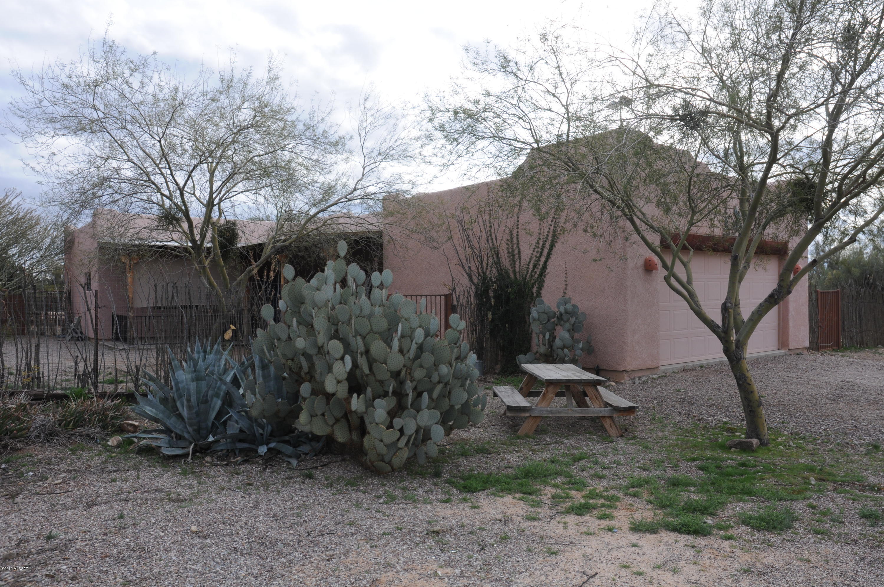 Beautiful home on 3 acres bordering Tucson Mountain Park. Stained concrete floors, Knotty pine kitchen cabinets. Horse corrals, arena, tack room and hay shed. Gated access to open land. No one can build behind the property. There are currently 2 manufactured homes also on the property which rent out at $500 per month each. You can make some easy money or remove for more privacy. This is a very nice home!