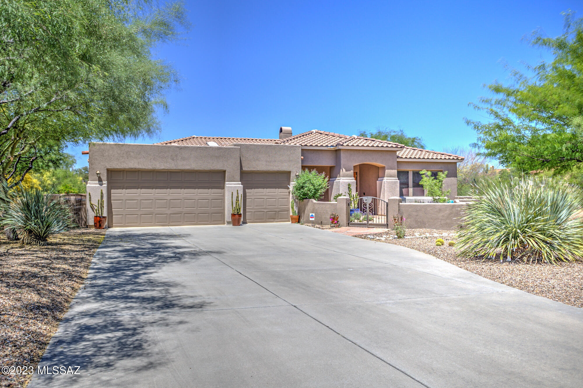 You don't want to miss this well-appointed AF Sterling home in the heart of Oro Valley on private cul-de-sac across from the community park. This prestigious, gated community offers luxury and beauty at first glance with a walk through the courtyard entry. Open, gourmet kitchen boasts 42'' cherry cabinets, granite slab counters, SS appliances, and a breakfast bar. Home features a split floor plan, spacious primary suite that includes a newly renovated bath w/ dual vanities, walk-in shower, separate commode room and WIC. Guest ensuite w/ shower and quartz countertops welcomes family or friends. The kitchen overlooks the spacious great room w/ entertainment center. and cozy fireplace for those cool, Tucson evenings. The dining nook leads to your backyard paradise. Enjoy north facing... 67 ac. lot w/ stunning views of the Catalinas to the east. Wonderful outdoor entertaining area w/ built-in BBQ grill, wood burning fireplace, paver patio, banco seating, surrounded by a lovely landscape. Welcome home!