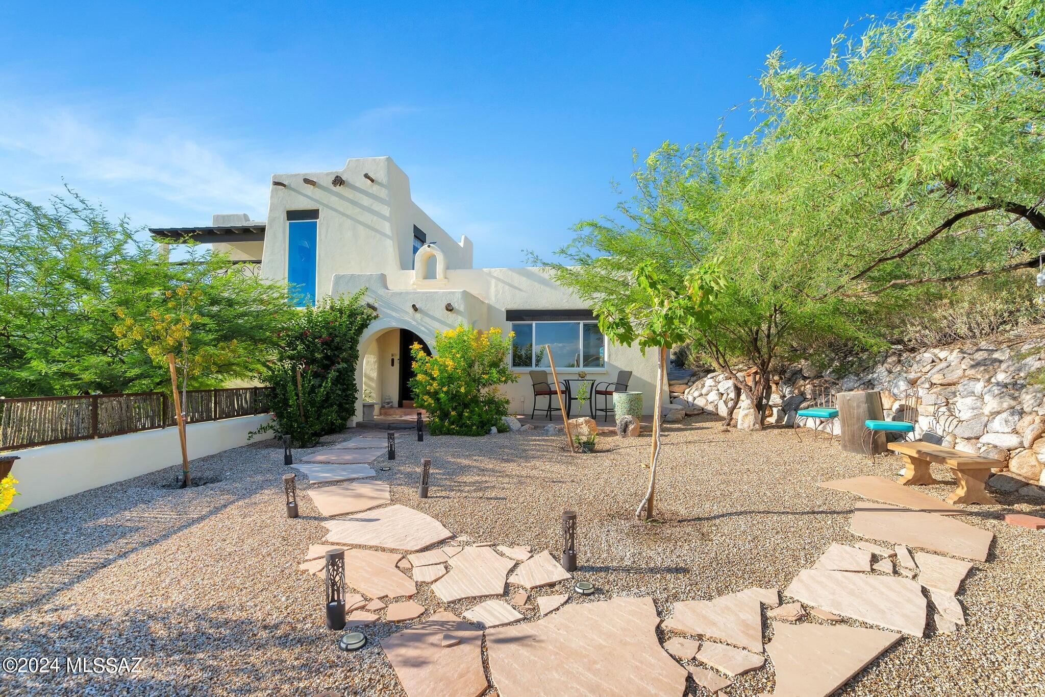 Stunning & remodeled home in desirable Catalina Foothills community of Cimarron Foothills. Enter through the inviting & professionally landscaped front courtyard into this 3 BD/2 BA/2,211 Sq.Ft home has been meticulously updated with no details spared. This tri-level home offers NEW windows, New kitchen, Updated Bathrooms, Custom front door, NEW alder wood doors/trim, interior/exterior paint, NEW roof, expanded asphalt driveway, NEW wood headers over windows & so much more.  Large family room is perfect for entertaining w/woodburning fireplace & custom accordion style doors to patio. Chef's kitchen has beautiful granite counters, custom mesquite wood style cabinets, island, stainless steel appliances, pot filler & large copper sink. Primary suite is spacious w/it's own private..(MORE)... .... balcony, perfect for stargazing & city views. Primary bath has barn door, dual vanities w/granite counters & mesquite wood cabinets, walk-in shower w/2 shower heads & walk-in closet. Guest bedrooms & bathroom are located at lower level for added privacy. Backyard features majestic & close up views of the Catalina Mountain range. Enjoy entertaining w/the outdoor kitchen, landscaped backyard, sitting areas & replastered pebble tec spool. Driveway leads to guest parking & 2 garage w/plenty of space to park.