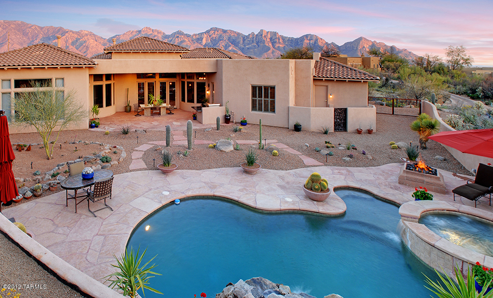 Custom home in the luxury gated community, The Estates at Honey Bee Ridge. Home hosts; marble floors, soaring ceilings, & gorgeous views of the Catalina Mountains.  Large chef’s kitchen w/stainless steel appliances, limestone counter tops, huge island, entertainment bar, walk-in pantry, breakfast nook,and built-in buffet.  Great room with fireplace overlooks the pool; separate formal dining and living rooms enjoy Pusch Ridge views.Master bedroom hosts his and her bathroom wings plus
 separate walk-in closets.Six Large bedrooms each w/ private en-suite bath containing custom limestone countertops and sinks. Professionally landscaped backyard has pool, spa, BBQ, covered patio, fire pit, & waterfall. Elegantly appointed, move-in-ready! Additional amenities list attached! DO NOT MISS THIS O