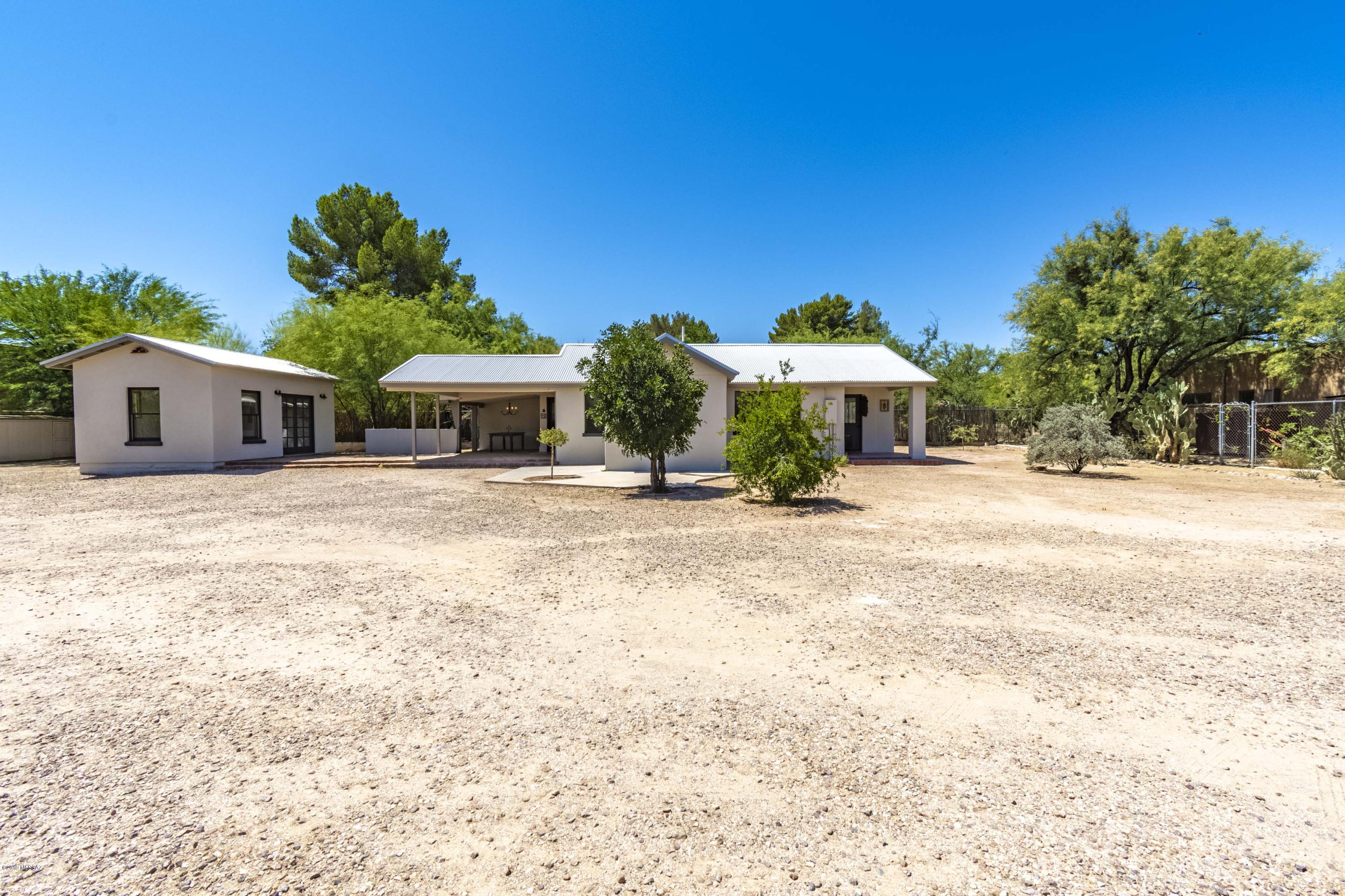 Welcome to the Domingo Romero Home. A rare opportunity to own a Ft Lowell Historic District home! Tucked out of sight on a very secluded, huge lot with tremendous Mountain Views. Feels like country living in the middle to town.  Inside you will find old world charm with a large gourmet kitchen sure to please any chef with the original tile flooring, beautiful cabinetry and modern appliances. The living room in full of light with built in bookcases, high ceilings and an abundance of natural light. The Studio would make a wonderful art studio or a home office with mountain views and high ceilings. This property has so much to offer with tons of room to expand. Surrounded by peace and quiet with such great seclusion! Owner is a licensed Broker and listing agent.