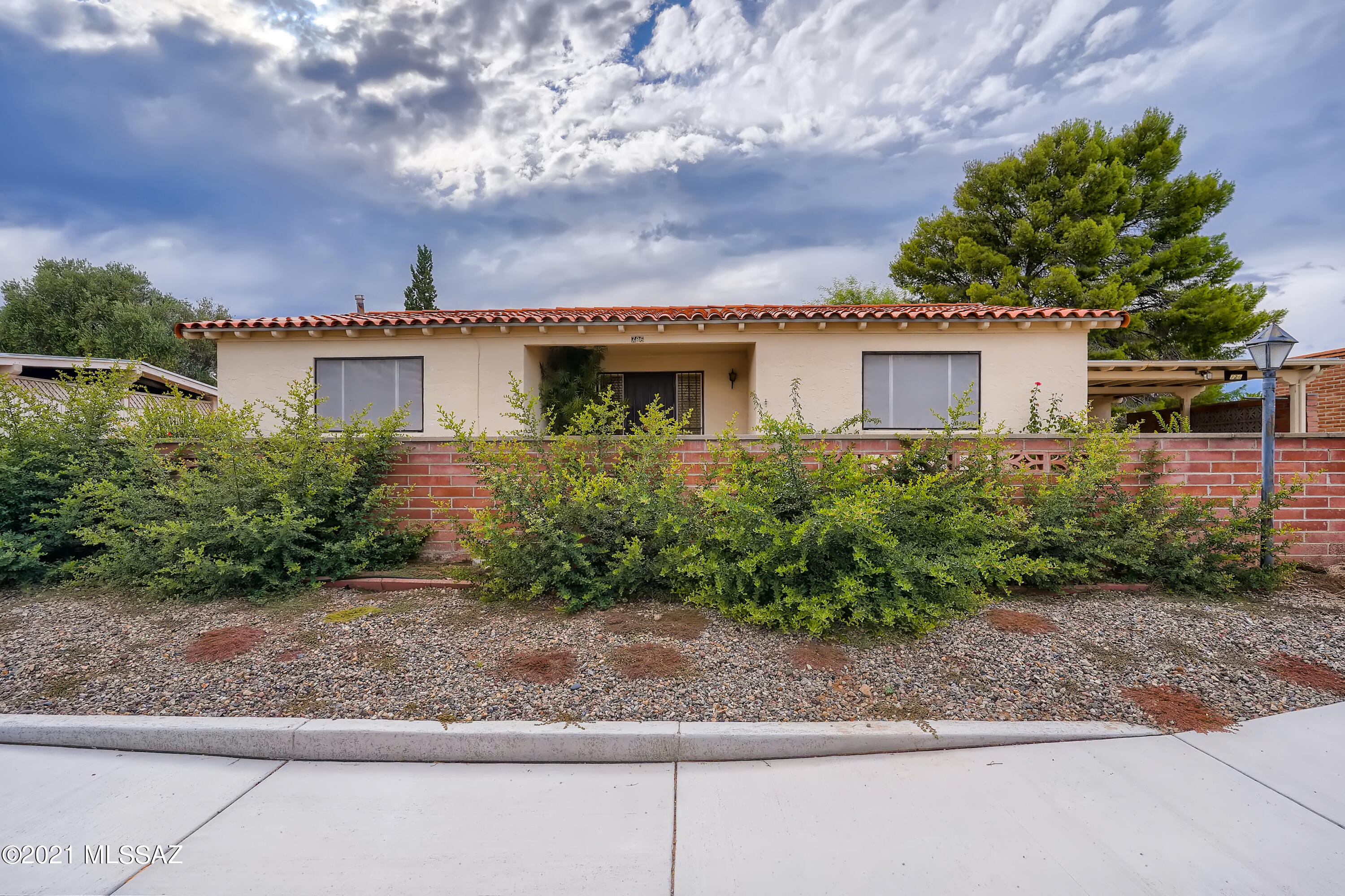 This charming 2 bedroom, 2 bathroom home in Green Valley is exactly what you have been looking for! A cozy sun-filled sitting room greets you, inviting you to take off your shoes and relax. You will love cooking in the kitchen, which offers a breakfast bar and an enormous amount of pantry and cabinet space. A sliding door separates the kitchen from an additional living area, an ideal place to entertain guests. Find peaceful solace in the primary bedroom, which comes complete with an en suite bathroom and a sizeable closet. Trees and greenery bring life to the backyard, a private retreat for you to bask in the sun and enjoy a morning cup of coffee. Museums, parks, and restaurants surround the nearby I-19, giving you abundant options for entertainment!