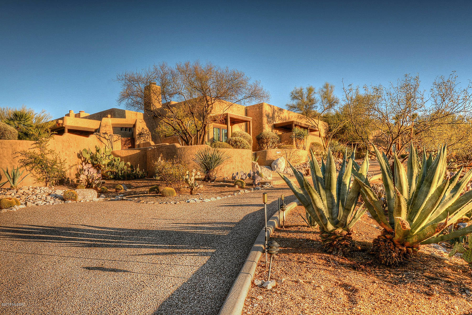 This large Alta Vista home is perched upon a hill offering stunning mountain views. Upon entering this beautiful property you will be at peace as you lounge by the exquisite pool as you take in the Catalina Mountains or as you sit by the fire in your private court yard, surrounded by nature. Not only does this house feature a split floor plan enabling ultimate privacy, but you will love the 2 bedroom guest house that has 1 & 1/2 baths, its own kitchen and private covered patio.  This home also has its own private studio with a separate entrance! With plenty of storage, guest parking, a fully equipped guest house and fabulous views, this home offers all you could want and ever need in a foothills home.