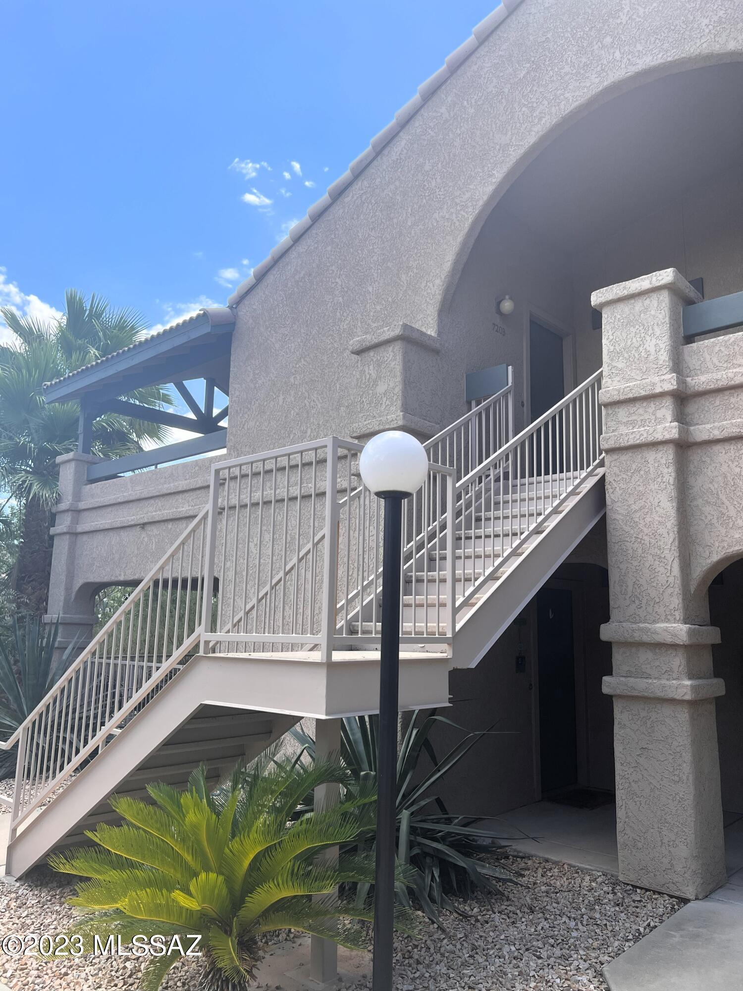 Fantastic 1005 square foot, northeast-facing, 2 bedroom, 2 bathroom, 2nd floor condo with lovely views of the Santa Catalinas and Rincons from your wraparound, covered patio. Enjoy beautiful Catalina & Rincon mountain views and the sunrise while sipping coffee or tea outside or snuggle up in front of the wood burning fireplace on cold winter nights. New air conditioner, water heater, stainless fridge, oven, microwave, and dishwasher installed in the last 2 years. Unit includes washer and dryer too. Schedule your showing before this one's gone!