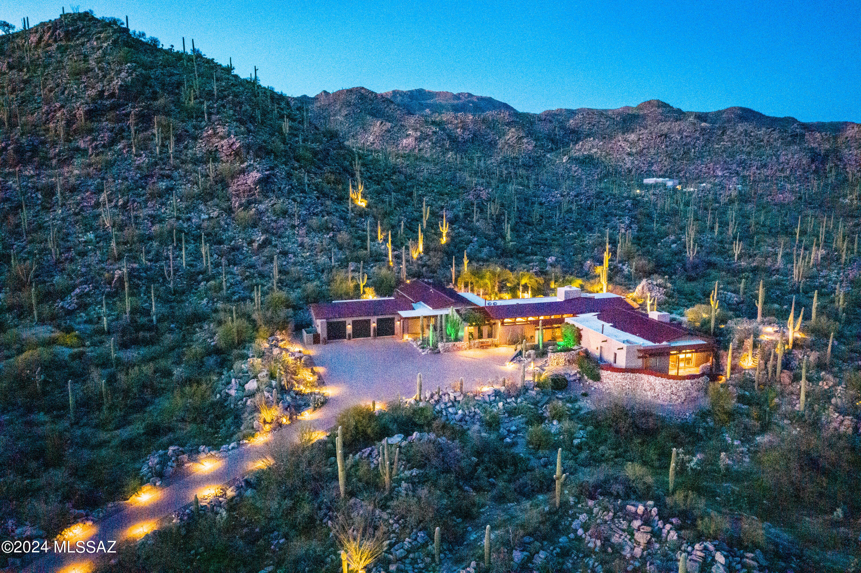 Stunning Southwest Contemporary home on over 4 acres.  Enjoy the Private living in exclusive Saguaro Ranch guard gated community.  Travel through the private tunnel and ranch gates to this gorgeous piece of the Sonoran desert.  This home is filled with the finest of finishings and luxury living.  The kitchen is a Chef's dream with Subzero Refrigerator, Bertazzoni Range, Wolf Warming Drawer, 3 dishwashers.  Primary bedroom includes a full morning kitchen with fridge, micro and dishwasher. Be 'Wowed' by the private spa on the bdrm patio with breathtaking views. Ensuite with huge closet, walk-in shower, tub and 2 water closets. The outside oasis includes beautiful pool and patio, firepit perched high for 360 views and the most amazing absolutely gorgeous outdoor kitchen!! No expense was spared in this recent remodel! Every detail is included right down to the beer tap and pizza oven. Perfect for entertaining or a relaxing night home!  3 car garage has 2 mini splits, air filtration and washer/dryer.  Home automation with URC audio/visual system.  This home offers the utmost in luxury living, privacy and desert beauty.