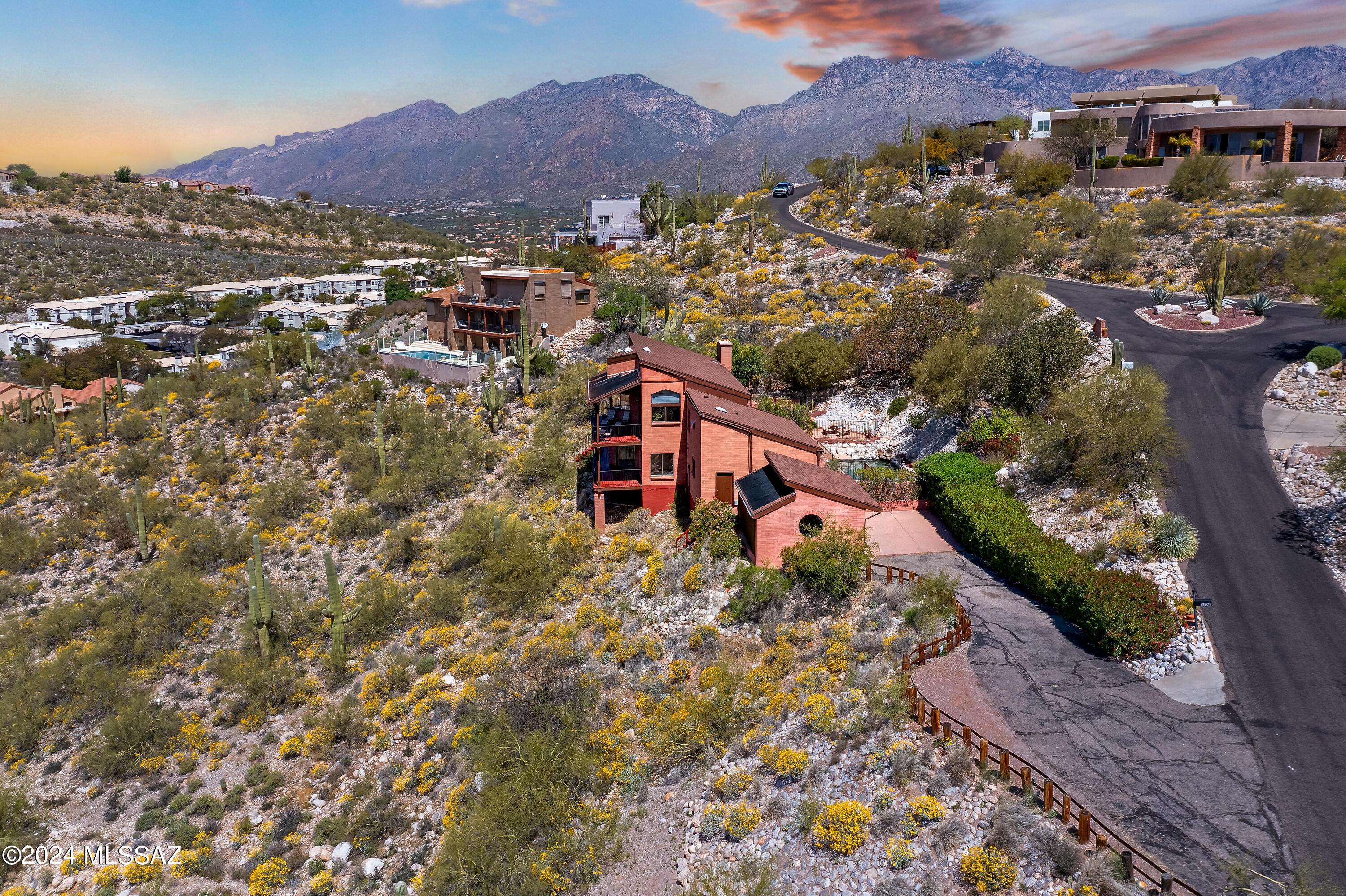 Breathtaking views in every direction.  This custom home is located in a gated community of high end homes in the Foothills. Home is 3062 sq. ft. on just over an acre providing privacy, mountain & city views, and close proximity to Sabino Canyon.  Home features great architecture with charm throughout.  Open and Bright floorplan with soaring ceilings, tons of natural light, Saltillo tile floors, cozy fireplace, huge picture windows and large wrap around decks.  Kitchen includes granite countertops, stainless steel appliances and custom lighting. Large primary bedroom suite has en-suite bath with large soaking tub, two walk in closets and double vanity.  Attached guest quarters includes kitchenette & bath perfect for guests or mother-in-law suite. Perfect outdoor entertaining area with sparkling pool, built in bbq, and brick paver patio. Home is exceptionally priced so bring your Buyers and show with confidence!