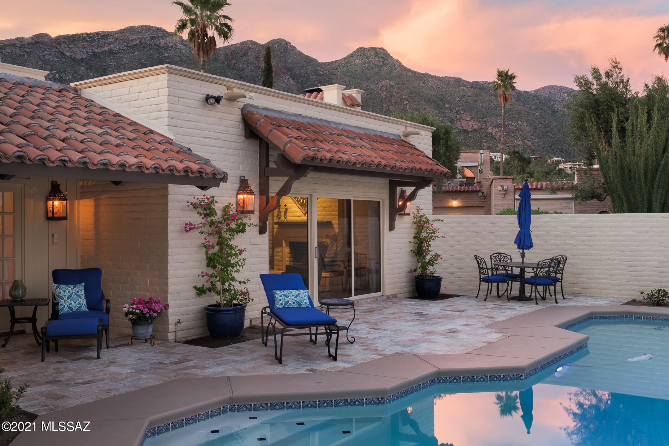 ONE OF A KIND! David Fraker Custom Built Home in the Prestigious Gated Community of Skyline Country Club Estates w/Amazing Catalina Mountain Views. Sitting on .24 acre lot w/Inviting Courtyard w/Beautiful Foliage & Tranquil Fountain welcomes you into a unique & comfortable setting. Enter through dramatic foyer w/14' beamed ceiling & stunning wrought iron chandelier & experience the warmth & comfort in this 3,580sf, 3BR, 3BA+Studio slump block home w/Saltillo tile floors, wood beamed ceilings & arched doorways. Upper level has a private guest retreat w/balcony. Recently updated stylish baths, Interior drywall repair & paint. Huge Master Suite  w/dual closets, updated shower, relaxing tub & wood-burning fireplace. Enjoy newer travertine patio, recently replastered sparkling pool/spa w/newer heater & pump & sitting area w/unobstructed Mountain Views. Incredible amenities w/golf, tennis, swimming & fitness. Private setting just minutes to dining & shopping. Oversized 2 car garage w/storage room.
