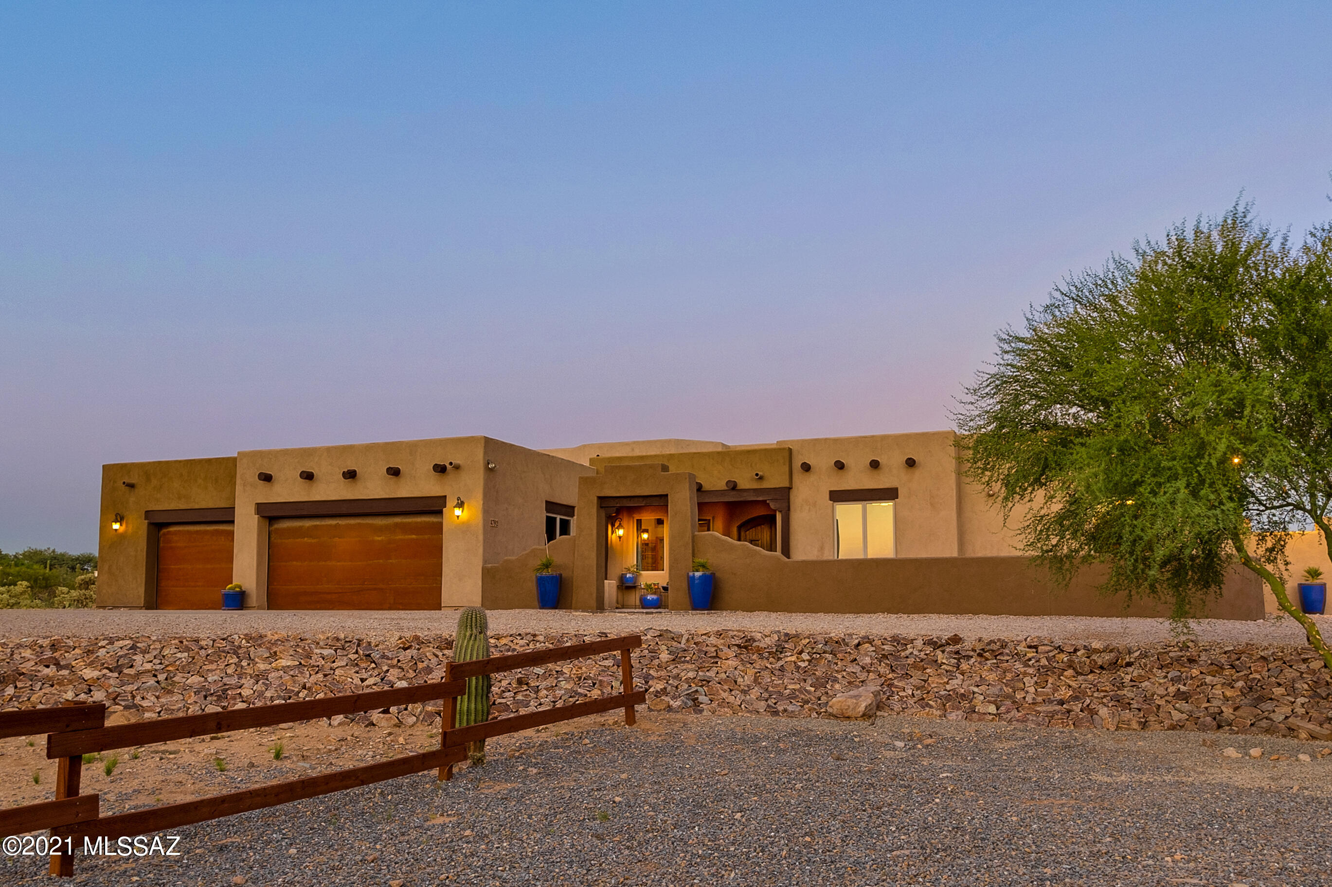 Beautiful custom Santa Fe home built in 2008 sitting on 3.31 acres at the end of a cul-de-sac of 5 private homes and wonderful Catalina Mountain Views - No HOA and horses allowed. Single story, 4,009 s/f, 5 bedrooms, 3.5 baths PLUS den, PLUS a huge recreation room. Vega beams and columns, stone fireplace, slate floors, Anderson windows - truly high end finishes at every turn.  Gourmet kitchen with double ovens and 7 burner gas cooktop, island with prep sink, warming drawer, custom cabinetry, granite counters.  This is a split bedroom plan (See floor plan in photos and documents) - at one end you have a huge owner's suite with dual closets, dual vanities, walk in shower and separate tub.  At the other end of the home are 4 more bedrooms - one is an ensuite with access to the backyard / pool area.  In the center of the home is a large bonus room with bath, full wet bar, ice maker, beverage fridge and dishwasher. Extra large laundry room and don't miss the beautifully epoxied floors in the large 3 car garage!  In the backyard is where you will spend plenty of time as the owners have spared no expense! Truly an oasis - extended pavers, pool with large spa, full sunken outdoor kitchen, outdoor fireplace, multiple sitting areas, large turf area, basketball pad, extensive landscaping - you won't ever need to leave - east facing for amazing Catalina mountain views. Bring all your toys and enjoy your desert oasis!