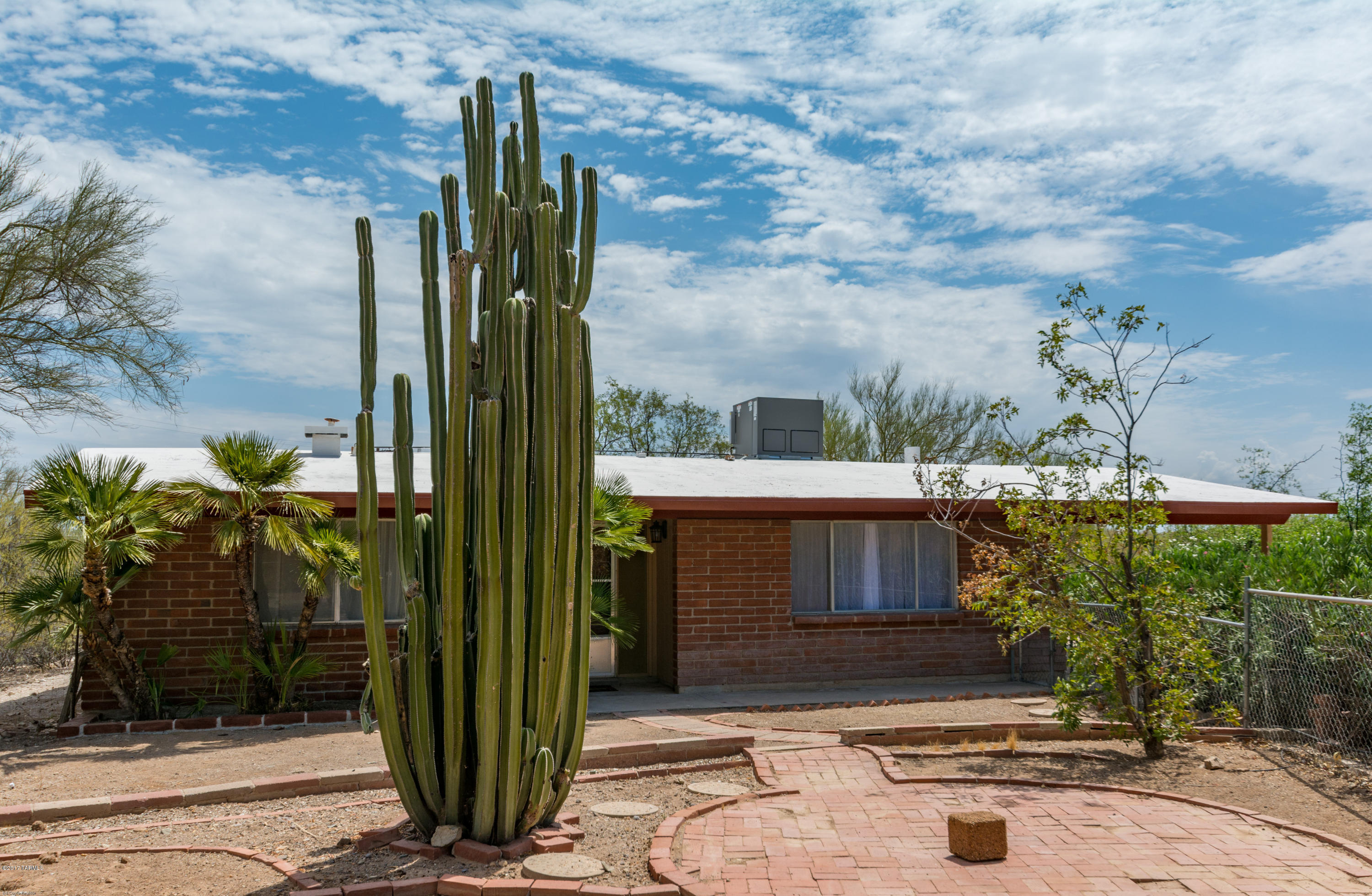 Recent appraisal performed. Attractive 3 bdrm, 2 bath adobe home situated on 3.37 acres. New carpet  installed on 10/5 Accessible to riding trail, perfect horse property. No CC&Rs, no HOA. Enjoy the serenity of the natural desert w/wildlife water Pond. Lose yourself w/Mountain views,breathtaking sunrise & sunsets. Private,quiet property w/fenced front & backyards, surrounded by Mature trees makes you feel like you're living in your own desert oasis, yet only 5 minutes to I-10 & only 20 minutes away from downtown Tucson! Numerous updates! See below. Fresh paint inside and out, New A/C, New Solar Energy Roof Coating & Facia, Hot Water Heater, New lighting fixtures, new plumbing fixtures, bath vanities w/marble tops. Kitchen opens to family room w/large stone fireplace. Huge laundry room w/tons of storage. All Appliances sta New carpet  will be installed on 10/6. There are endless opportunities to make this propert your own.