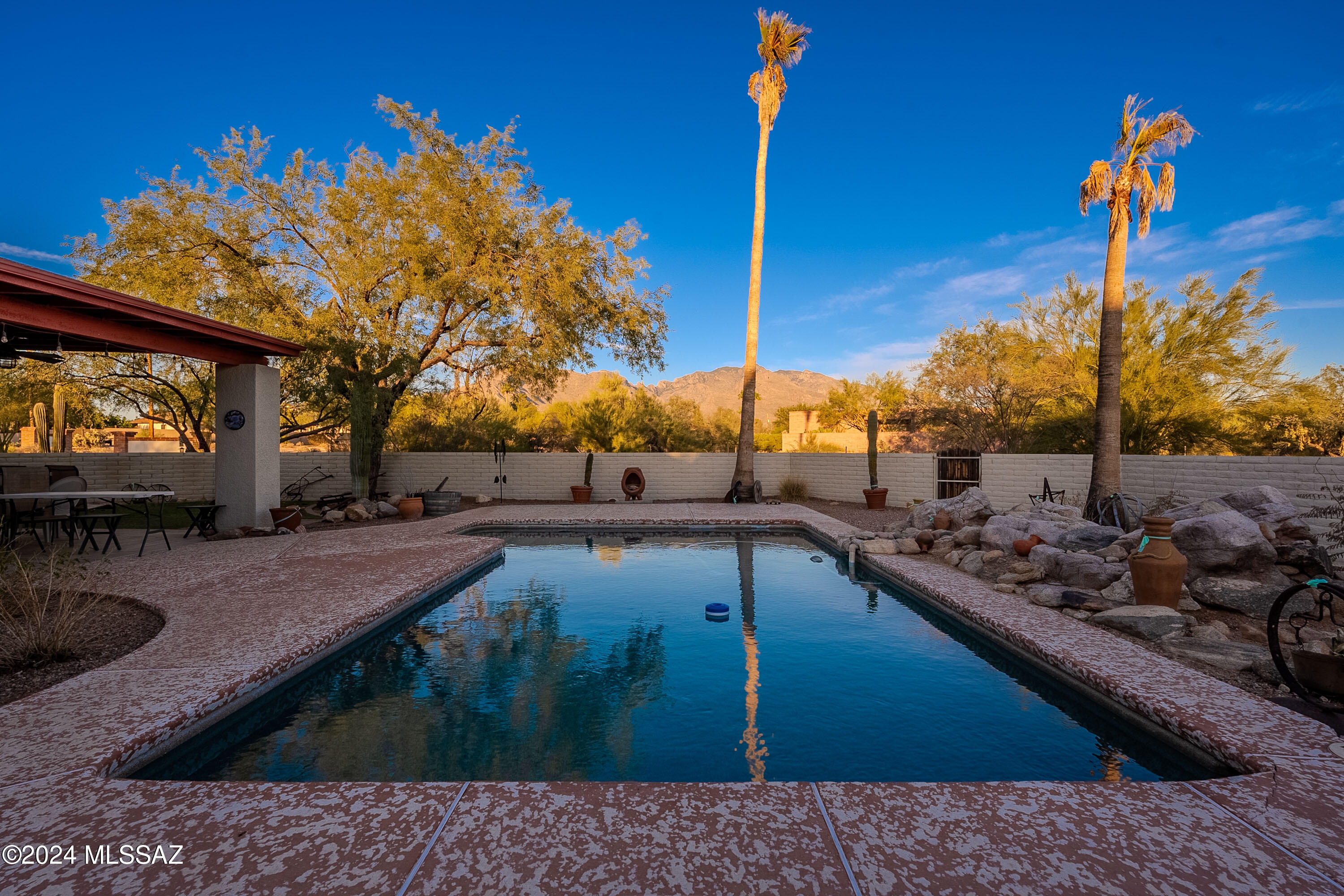 Custom built & uniquely designed home by Michael Ginsberg - located in the coveted community of La Mirada.  NO HOA, only 11 homes & less then 1 mile to Oracle Rd.  Breathtaking Catalina Mountains views, this secluded property offers 2750 sq ft, 4 beds, 3 baths, 3 car attached garage + recently added 2,300 sq ft detached RV garage (46 x 50 - poss 9 more vehicles). This large addition, brings enclosed parking to potentially 12 cars (not including pre-wired for car lift). Workshop set up, RV electrical installed, grey water sink, welding, 4 garage doors - maybe even a guest house? Beautiful saltwater pebble-tec lap pool, new Milgard windows (2024), east covered patio w/ turf &  new carpet 10/24. Home has phenomenal layout & is just waiting for a new owner to fall in love & make it there own.