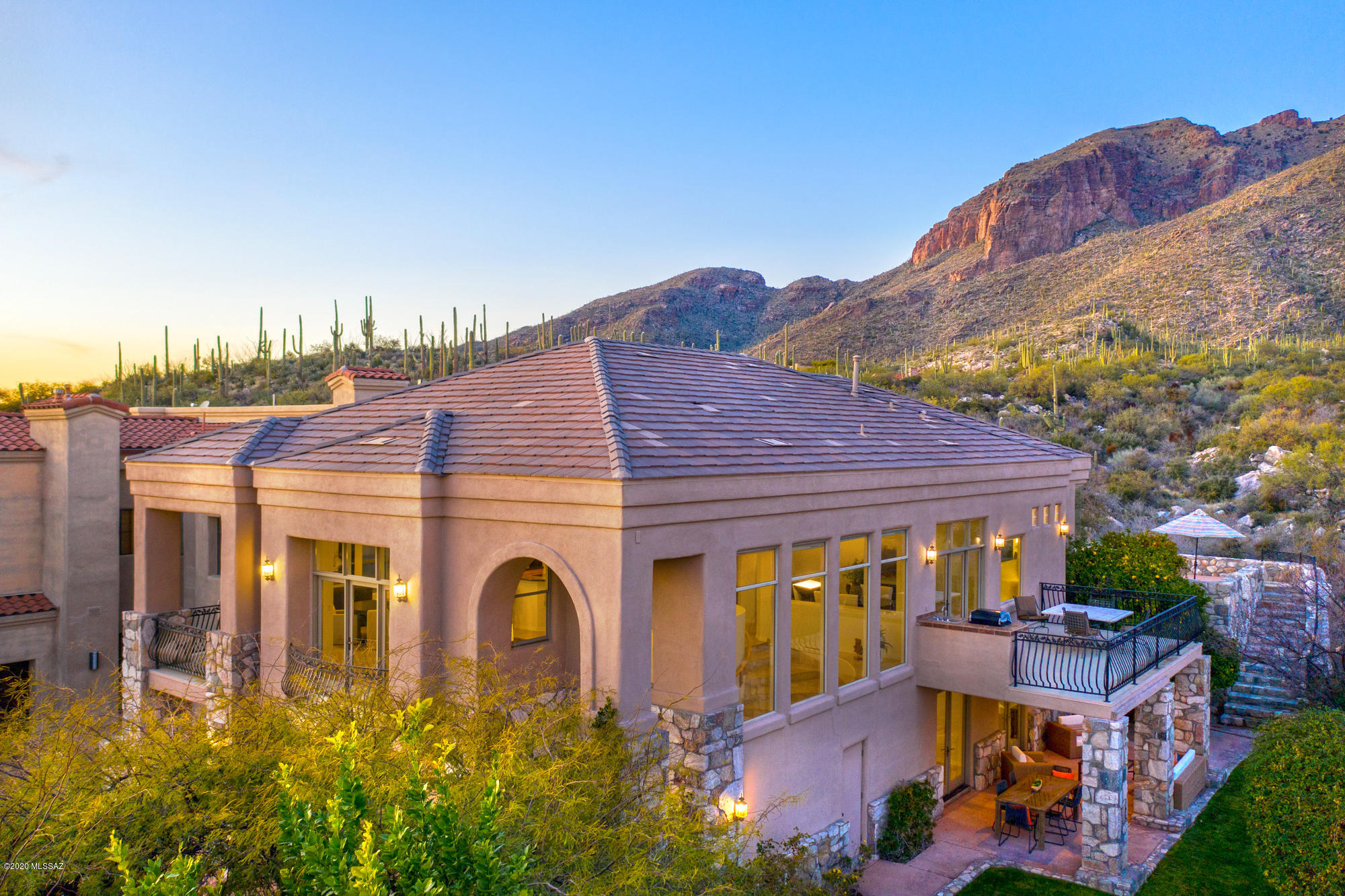 Immaculate contemporary home high above they city, sits within gated community. The property backs up to the Coronado National Forest; enjoy unobstructed mountain views and sparkling city lights for miles.  The inviting outdoors features a lush lawn, mature citrus trees, covered patios, large balconies and a naturally flowing water creek.  Tall ceilings, open floor plan, and large windows will keep everyone engaged and inspired.  Apart from the natural and made aesthetics, this home features superior construction with steel framing.  Added benefits: School District 16, Close Proximity to La Encantada Mall/ AJ's, near popular golf courses, walk to the trails from your backyard 

Welcome to a quiet and serene lifestyle.