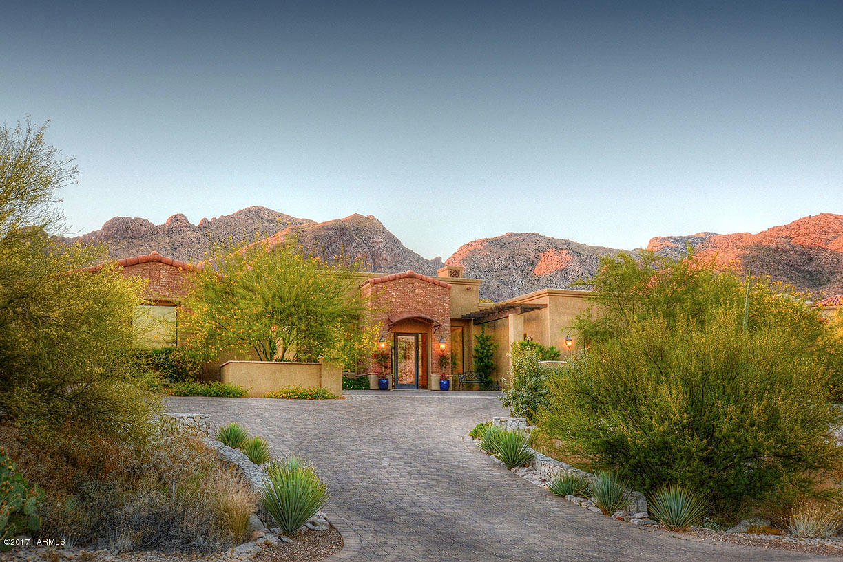 Outstanding 2013 architect designed contemporary in prestigious, gated Pima Canyon Estates in Tucson's Catalina Foothills with 4844 sqft, 4 bedroom split plan with ensuite baths plus studio or exercise room, city & mountain views. Courtyard entry with brick pavers leads into living room with high ceilings & windows with lots of light, travertine floors throughout, beamed ceiling & fireplace with cantera stone surrounds. Adjacent kitchen/family gives the home a ''great room'' feel and offers gourmet kitchen with granite counters, designer SS appliances, alder cabinets & doors, center island, separate breakfast bar and floor to ceiling brick fireplace. Glorious master suite features garden tub & oversized walk-in closet with built-ins. Landscaped rear yard has expansive porch w/paver patio. fire pit and fireplace. Three car garage, structural and 2-10 warranties and so much more.