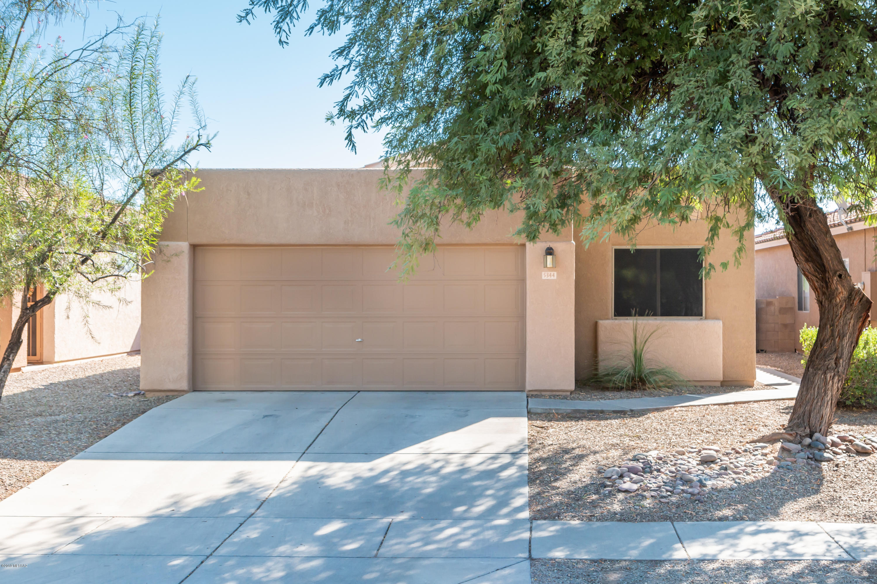 Thank you for visiting this very well-kept 3 bedroom, 2 bath home in the quaint community of Riverside Crossing. A thoughtful split floor-plan places the master bedroom, with large walk-in closet, opposite the guest bedrooms and adjacent hall bath. Enjoy a cozy fire in the family room as winter approaches or enjoy a quiet evening admiring the mountains on the brick patio out back. Plentiful shade is also provided year round under the beautifully constructed patio cover with added accent lighting. Conveniently located close to shopping, I-10 and the central corridors of Tucson and Oro Valley. Community pool, front landscaping and refuse all included in HOA payment and a Home Warranty to be provided by the seller. There are few properties under $200k as nice as this home.