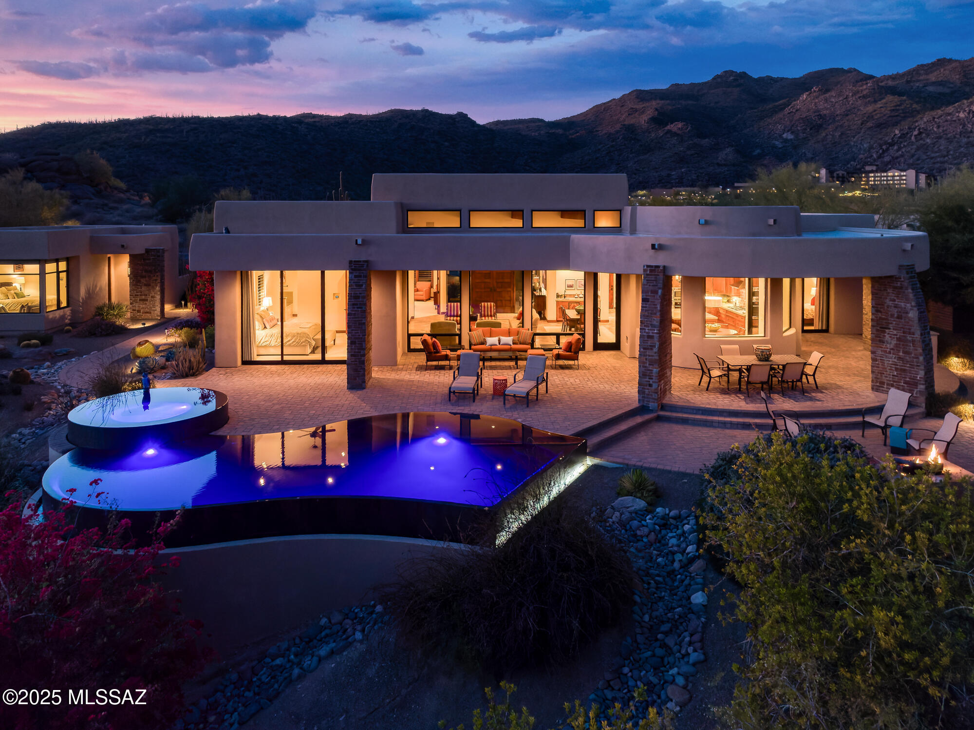 Situated at the base of the Tortolita mountains overlooking the 14th Fairway of the Gallery North Course on an elevated, private homesite in the exclusive gated community, The Overlook at the Gallery in Dove Mountain. Exceptional views in every direction & from every window of the mountains, the iconic Tucson sunrises & sunsets, & the twinkling city lights in the valley below. This expertly designed one-level desert contemporary residence has three en suite bedrooms, a powder room, & a separate guest casita. A blend of warm colors & natural materials artfully woven throughout delivers understated luxury desert living that compliments the lush desert environment. A large motor court lined in pavers leads to a gated courtyard with an impressive mahogany double doors front entry continued... Bright & open great room with soaring wood-beamed ceilings, walls of windows streaming in natural light, a gas fireplace, & natural stone flooring. The dining area & wet bar with sink is adjacent to the gourmet kitchen with custom alder wood cabinetry, granite counters, custom backsplash, & high-end stainless-steel appliances. Breakfast nook with large windows is the perfect place to enjoy a casual meal & enjoy the privacy & views. Spacious owner's suite with up-close mountain views & sliding glass doors to the patio. Owner's suite bath with dual-sink vanity, soaking tub, & separate shower. The separate guest casita can be used to entertain guests, an art studio or set up a home office. Big walk-in pantry with custom shelves. Laundry room with sink & extra storage. Three-car garage with epoxy floor and storage cabinets. Low-care backyard with a deep covered patio lined with pavers, vanishing edge pool & spa by Azure Gallery LLC, gas firepit, putting green, & built-in BBQ. This home is designed for seamless indoor/outdoor living & enjoying the Arizona lifestyle to the fullest. Convenient location just minutes from the Ritz Carlton Resort & Spa in Dove Mountain. Join the Club at Dove Mountain for the ICON 63 membership which allows access to Dove Mountain & the Gallery golf courses, the Gallery Sports Club & more! Close to Interstate 10 providing easy access to shopping, restaurants, & downtown Tucson. Just over an hour to Sky Harbor airport in Phoenix for more direct flights.