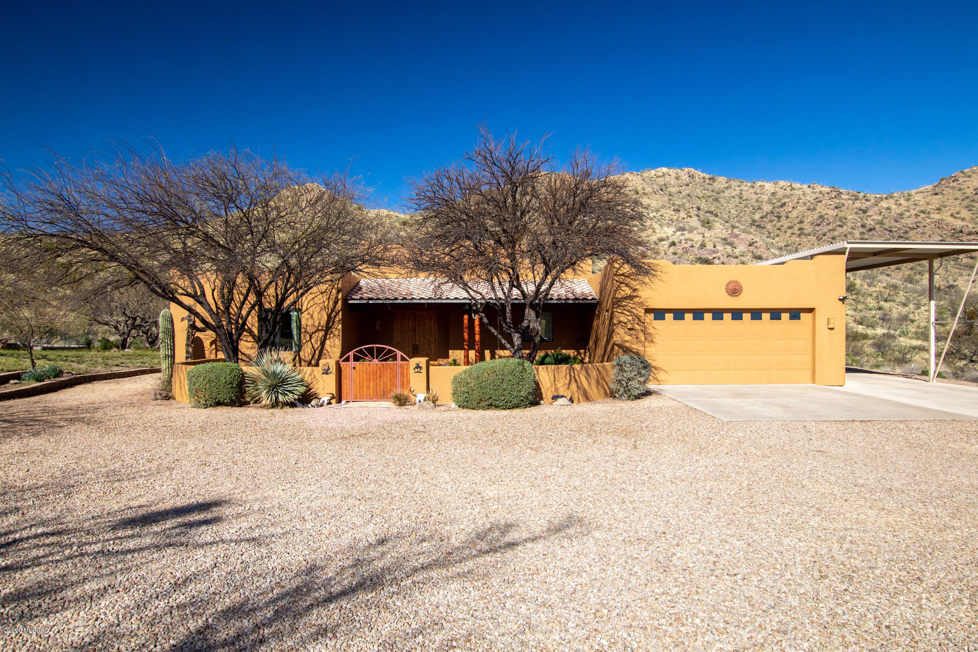 Incredible 5 acre property w/ a mountain ridge just steps from your back door! Endless hiking, deer that come for their daily carrots & serenity your heart didn't know it needed! Extended height awning w/ electric; perfect for RV/boat or easily holds 4 addtl. cars. Horse facilities w/ covered stall & tack room. PRIVATE WELL (gets 12 gal a min!) & has 1,100 gal storage tank. Rustic 5 bed, 3 bath home features stained concrete floors throughout, wood ceilings & knotty alder cabinets. Meticulously cared for 1 owner home. HVAC only 3 yrs old, NEW dishwasher & water heater, NEW bathroom fixtures, NEW exterior paint & roof was just re-coated! Move right in! Gas stubs avail if you prefer propane. No HOA! Could ask owners of neighboring vacant lots if willing to sell; increase your privacy!