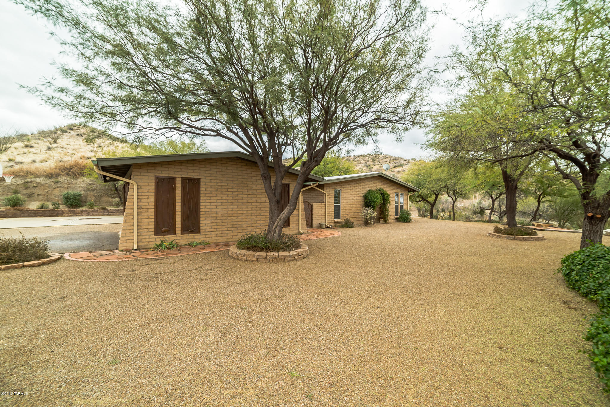 We have it all! Great house, great views, great property. A beautiful home nicely updated with granite, tile, Hickory cabinets, smooth top oven, side by side refrigerator, WALK-IN pantry, gas fireplace, 2007 heat pump, 2009 well pressure tank and pump, 2014 roof resealed, gutters and downspouts installed, drip system, a retaining wall and new gravel. The garage doors, courtyard gate and entry door are custom iron work and the laundry/utility room has plenty of space. The master suite is complete w/walk in closet and private bathroom. The HOME SITS ON 4.996 ACRES and we do have a level yard and patio, a pad for basketball or RV, a hill in back and a hill in the front going down to a nice level plot of land perfect for horses, toys or pool.