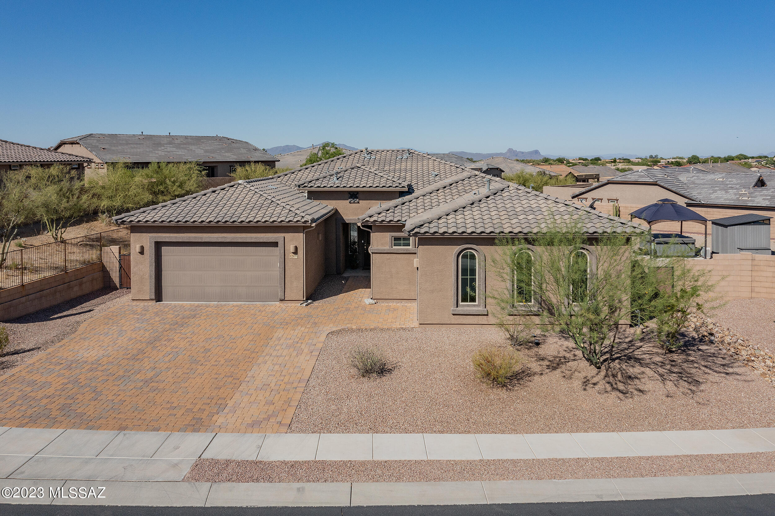 Much sought after Amazing Next-Gen Home in pristine condition. Dramatically designed home with 10 ft ceilings, open floorplan, and plenty of windows to enjoy the views. Includes Gourmet Kitchen with upgraded Monogram appliances. Separate 1 BR guest quarters with private entry from the front courtyard. It has a kitchen with 42'' cabinets, granite countertops, a large living area and breakfast nook, a stackable washer/dryer, a bathroom with a walk-in shower, and a separate entrance to one car garage. Enjoy the elevated premium extra large lot laid out for privacy with a custom heated swimming pool with a waterfall. The basketball court and casita have magnificent mountain views of the Tortolita mountains, a private hot-top, and an extra storage area.