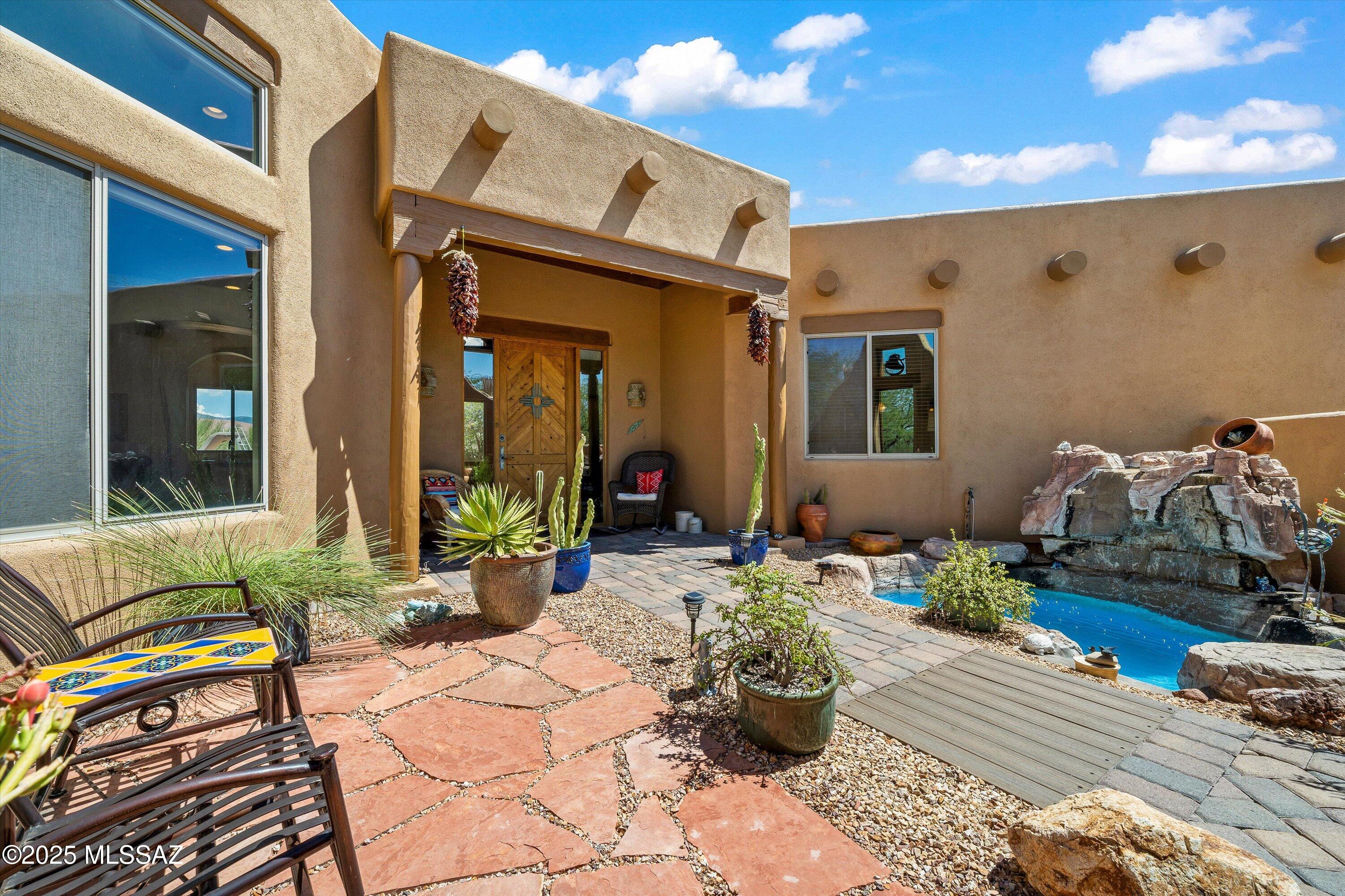 **Outstanding views in gated Coyote Creek!** This 4BR/4BA, 2,973 SF home on 1.5 acres offers privacy in the Vail School District. Courtyard entry w/fountain leads to an oasis backyard featuring pebble-tec pool, spa, waterfall, slide, BBQ, kiva fireplace & pool bath. Family room off kitchen + formal dining. Primary suite w/kiva fireplace, patio access, soaking tub, double sinks, large shower & walk-in w/built-ins. Owner owned solar panels + new Heliocol solar for pool. Pelican whole-house water system. Oversized 3-car garage w/cabinets. Community trails, equestrian & rec center. Minutes to I-10, 25 min to major employers, 30 min to TIA, 35 min to  downtown Tucson.
