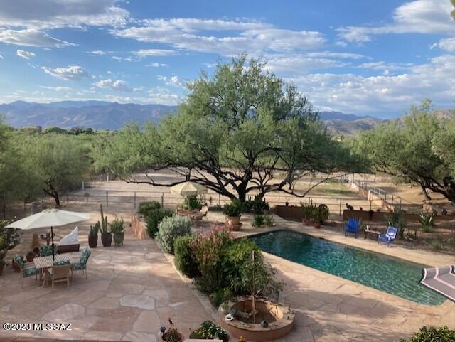 This oasis, nestled on 7.5 acres, is all about the lifestyle. A private, gated compound with horse facilities, tack room, barn, pool, guest quarters, flagstone patios, lush vegetation and unobstructed views in all directions. No need to trailer your horses, ride out to nearby trails from property. Enjoy the comfort of the main house with open concept, beam ceilings and Pella windows. Huge 3 car garage with workshop area and guest quarters (permitted as Rec Room) with its own full bath. Private well and City Water hook up. Agent related to Seller.