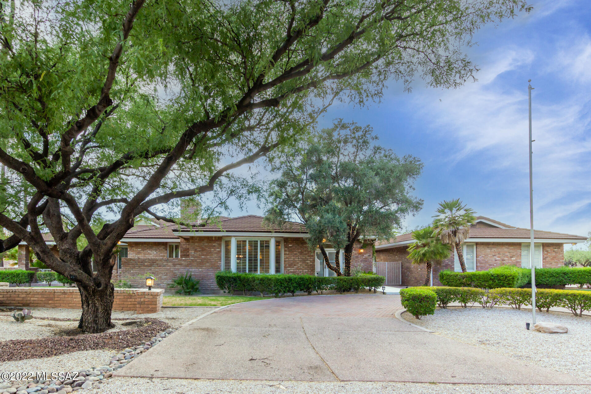 This home is your next oasis in our beautiful Arizona desert. Let's start in the hub of this home—the kitchen. It features Carrara marble countertops, a sub-zero frig, gas cooktop, skylights and ample storage. The great room expands into a dining area, built-in desk, powder room and living area. Down the hall are two bedrooms that share a Jack & Jill bath—along with laundry, storage and garage. In the opposite direction, the primary suite awaits with fireplace, sitting area, multiple closets and private patio. The primary bath features a walk-in shower, double vanities and jetted tub. Need some seclusion from the bustle of the great room? The living and dining rooms are waiting through the double pocket doors off the kitchen. Here you will also find the guest suite. Walk outside to the covered patio, a gorgeous pool and spa, a built in BBQ, and outdoor bathroom and shower. The newly installed pool safety fence is designed to be removable should you not need it. Schedule your tour today - you will not be disappointed.