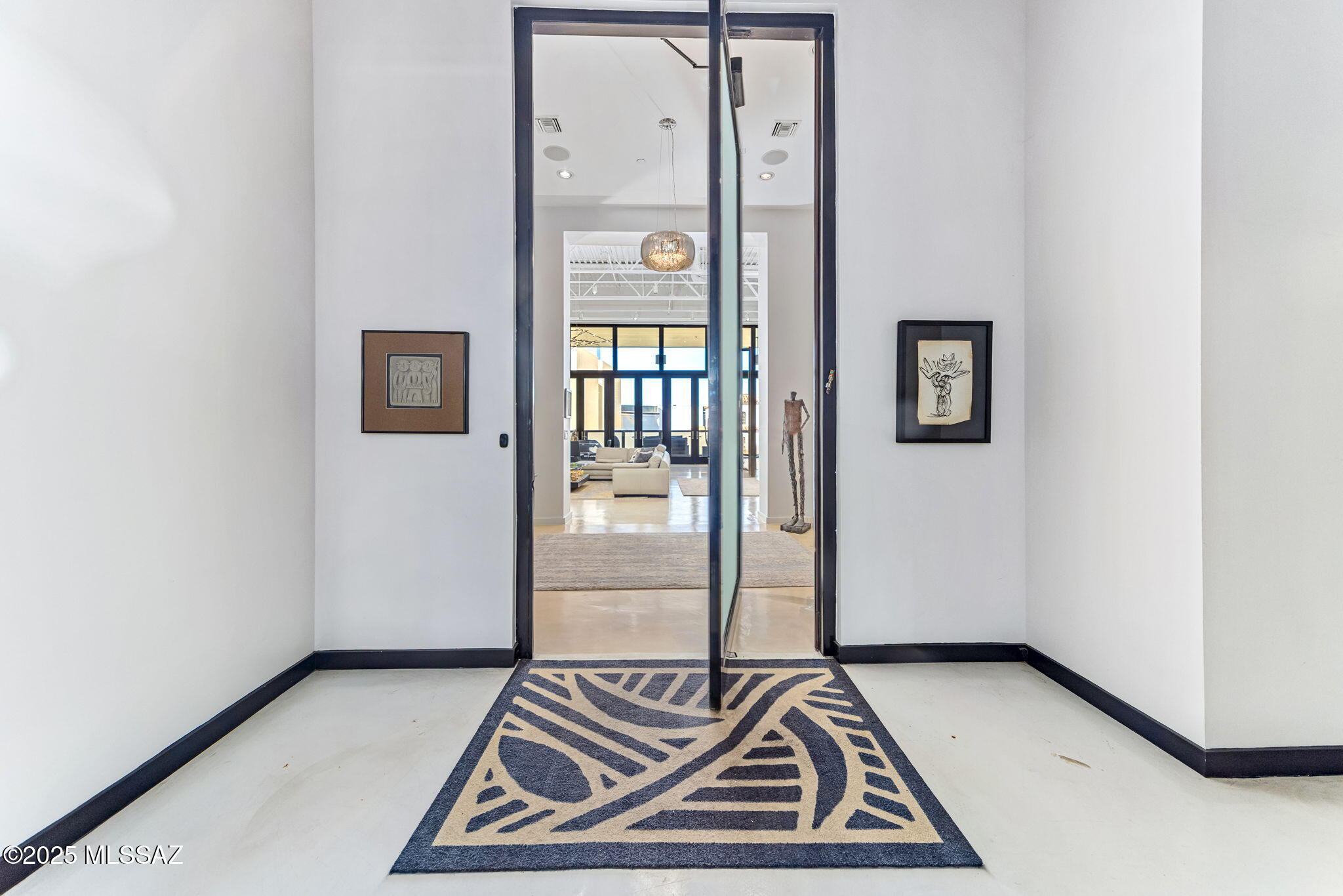 Luxury Loft Condominium in Downtown Tucson. Experience the pinnacle of downtown living in this one of a kind luxury loft, the only residence of its kind in the heart of Tucson. Boasting dramatic 20-foot ceilings and sweeping floor to ceiling windows, this home offers breathtaking north facing panoramic views and an abundance of natural light. Every detail reflects modern sophistication: polished white concrete floors, a state-of-the-art surround sound system, and a private steam room designed for ultimate relaxation. The open chef's kitchen is both stunning and functional, featuring designer cabinetry, premium appliances, and elegant countertops that make cooking and entertaining effortless.Step onto your spacious private balcony to take in the Tucson skyline or host guests under the desert stars. This exceptional downtown loft combines architectural drama with refined comfortperfect for those who value exclusivity, elegance, and the dynamic energy of urban living. This is Downtown Tucson luxury, redefined.