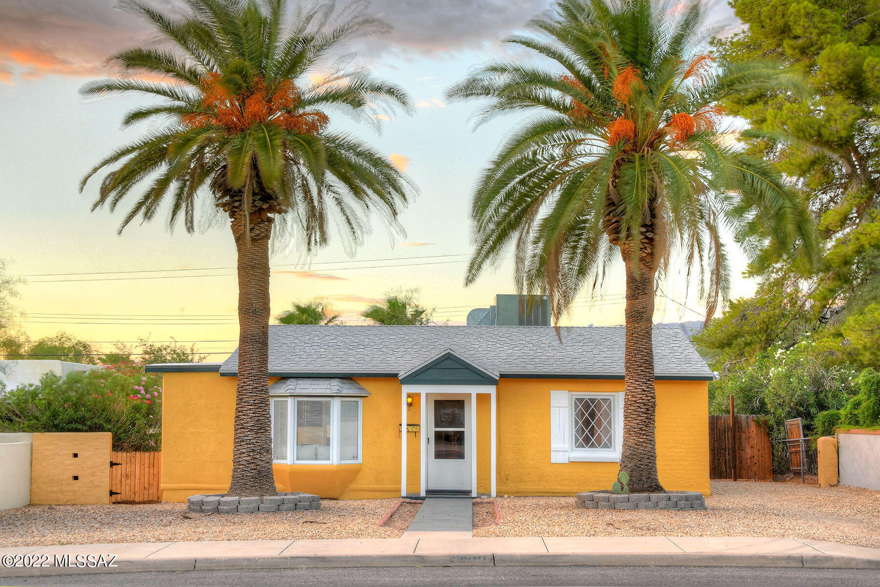 Picture perfect and truly charming home in the Blenman Historic District. Light and open living room with decorative fireplace, bay windows, real wood floors, lovely  dining area, remodeled  kitchen with tile countertops, gas stove, refrigerator, dishwasher, family room, beautiful white molding around  all windows and interior doors , 2 bedrooms plus office or 3 bedrooms and 1 full bath in the main house (1235 sqft), washer, dryer and brand new roof  Plus (244 sqft) guest house with wood floors and 1 full bath.  Enjoy the large backyard with covered patio, mature landscaping and mountain views.