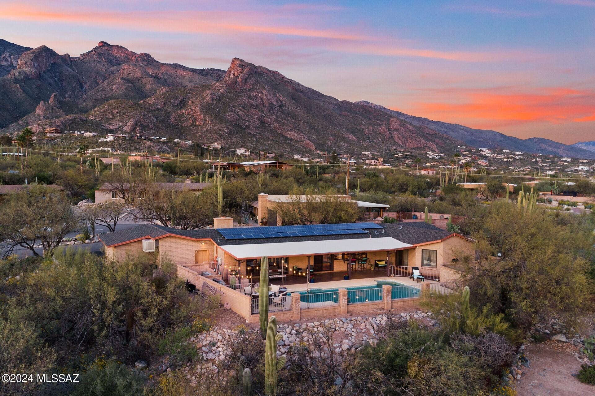 Nestled and Tucked into the base of the Catalinas, this single story home is a Foothills dream! Situated at the apex of the Foothills Clusters on large lot surrounded by wash. Open floorpan is cozy yet still perfect for entertaining! Primary retreat features 2 full rooms, vaulted ceiling, 2 w/i closets, laundry rm, slider to patio. Light&bright w/ walls of dual paned windows & breathtaking mountain/sunset/city views. Enjoy 180* views of the sparkling city below from elevated viewing deck and cool covered patio. Huge Pool. Flagstone front. Completely renovated over the past 4 yrs. NEW:paint,roof,A/C,pool equip,electric,plumbing,bathrooms,lighting,
smooth walls,trim,doors,refinished Saltillo,stained cabinets! Stunning Stone Tops.Citrus. 2.5 car garage. Energy efficient Block w/ newer solar Agent/Owner
