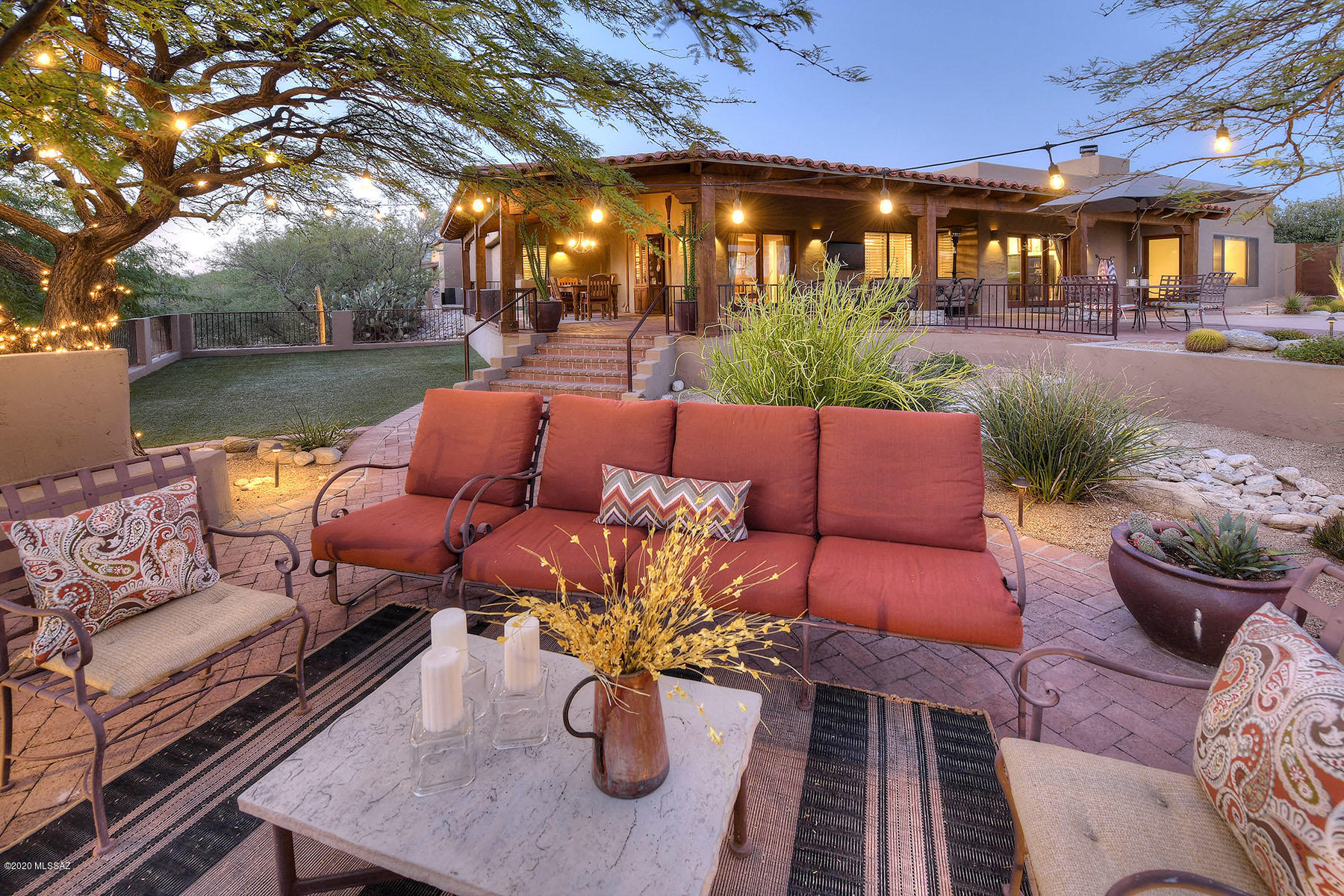 It is rare to find a home that truly defines inviting.  From the moment you step  through iron gates, into a beautiful courtyard, you will want to linger.  The interior draws you in just the same way.  It is said the kitchen is the heart of the home.  Picture white cabinets, concrete countertops, and an  island that says ''come gather around''.  Wonderful formal dining that embraces the courtyard thru glass doors. A great room with fireplace opens to the kind of wrap around patio that everyone wishes they had. Private master suite with sitting room, a cozy den with french doors opening to the outside.  Speaking of outside. Exemplifying the lifestyle of Tucson, the patios and pool are spaces for living complete with outdoor fireplace.  The perfect floorplan in every way.