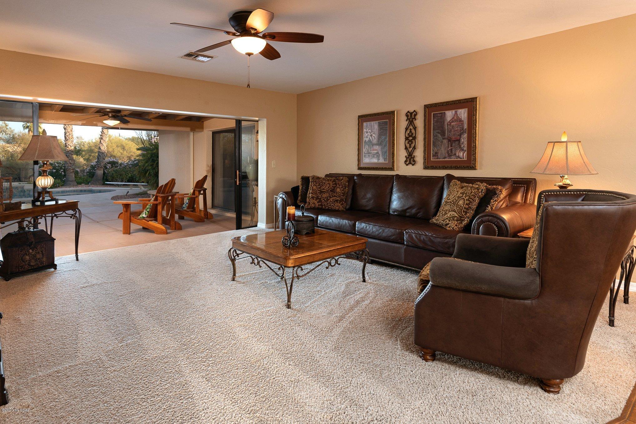 Gorgeous turn-key Foothills property offers an abundance of natural light and is perfect for entertaining. This 4 bed, 3 bath home with den/rec room is located in the desirable Shadow Hills Community and the Catalina Foothills school district. The updated kitchen opens to the cozy family room and offers new granite counters and backsplash, stainless appliances, gas stovetop and dining area. The owner's suite includes a gas fireplace, ensuite bath, and private access to the patio and backyard. The updated spa-like ensuite bath features an extended depth, executive height dual vanity, large walk-in shower, and vanity. The huge east-facing backyard is perfect for throwing socially distanced parties. Some of the highlights include a pebble Tec pool (resurfaced in 2019), two covered patios, built-in bbq, kegerator, outdoor fireplace, and incredible Catalina views. Pool and spa are on gas heater for winter-time swimming! The 3-car garage has low-care epoxy floors, and an evap cooler, making it a great place to work or workout year round. The den/rec room includes a closet, so it could be a 5th bedroom or converted to an additional guest quarters.