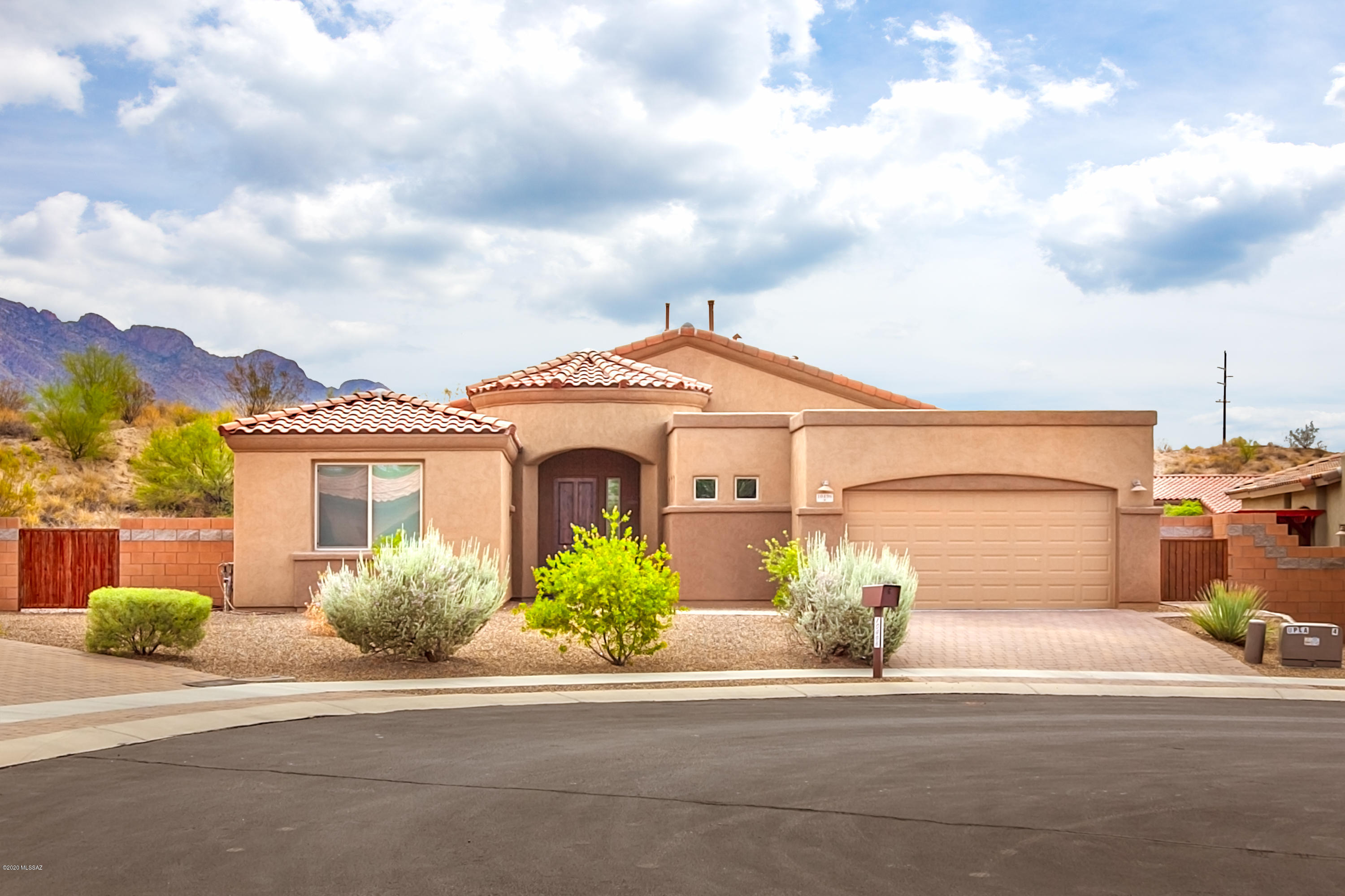 Rare opportunity to own an AF Sterling built home in a 16 home gated community in the heart of Oro Valley. Home features granite counter in the kitchen with island, induction heat gourmet cooktop, convection oven/microwave, pantry & roll-out drawers. Recessed lighting, over & under cabinet lighting, with hand blown glass pendant lighting, and is open to dining & great-room. Tile throughout, with plank tile in the main living areas & decorative tile in bedrooms & baths. The master bedroom/bath boasts dual closets, dual sinks, and a custom walk-in shower. Laundry with prep sink & cabinets matching kitchen & baths. The 2.5 car garage is upgraded with a 2' extension - plenty of storage. Outside is a 6' side gate & 3 outdoor areas. Artificial grass with pavers & open space behind. Other amenities include; solar tubes for natural, cool lighting, linen closets, soft-water loop, screened in patio with tile, fireplace, 8' sliding doors off great room.  All within walking distance to dining, shopping, and the park.  Home is on a cul-de-sac lot.  Add this to your list today.
