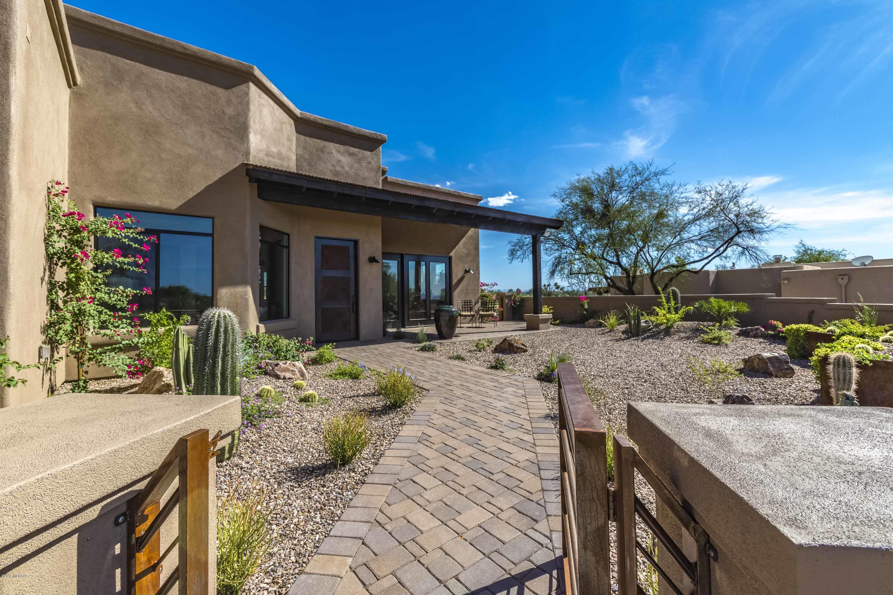 Stunning brand new, 2017​ ridge​top ​custom home at the end of a cul​-​de​-​sac in the Catalina Foothills. Sweeping mountain views, city lights​,​ a ​view of the 5th hole at Tucson Country Club​ and backing up to​ a​ protected ​wash & ​lush desert. Enjoy views from the expansive front and back porches and throughout the home. Paver driveway leads to front courtyard with custom planter. Enter into great room with expansive ceilings, ​gorgeous tile, views & a cozy ​Fireplace. All cabinets, alder doors, mirrors, hardware & mantel are custom​ made. Cook's kitchen offers granite counters and SS appliances & expansive island. Baths feature custom vanities finished in ​granite​
