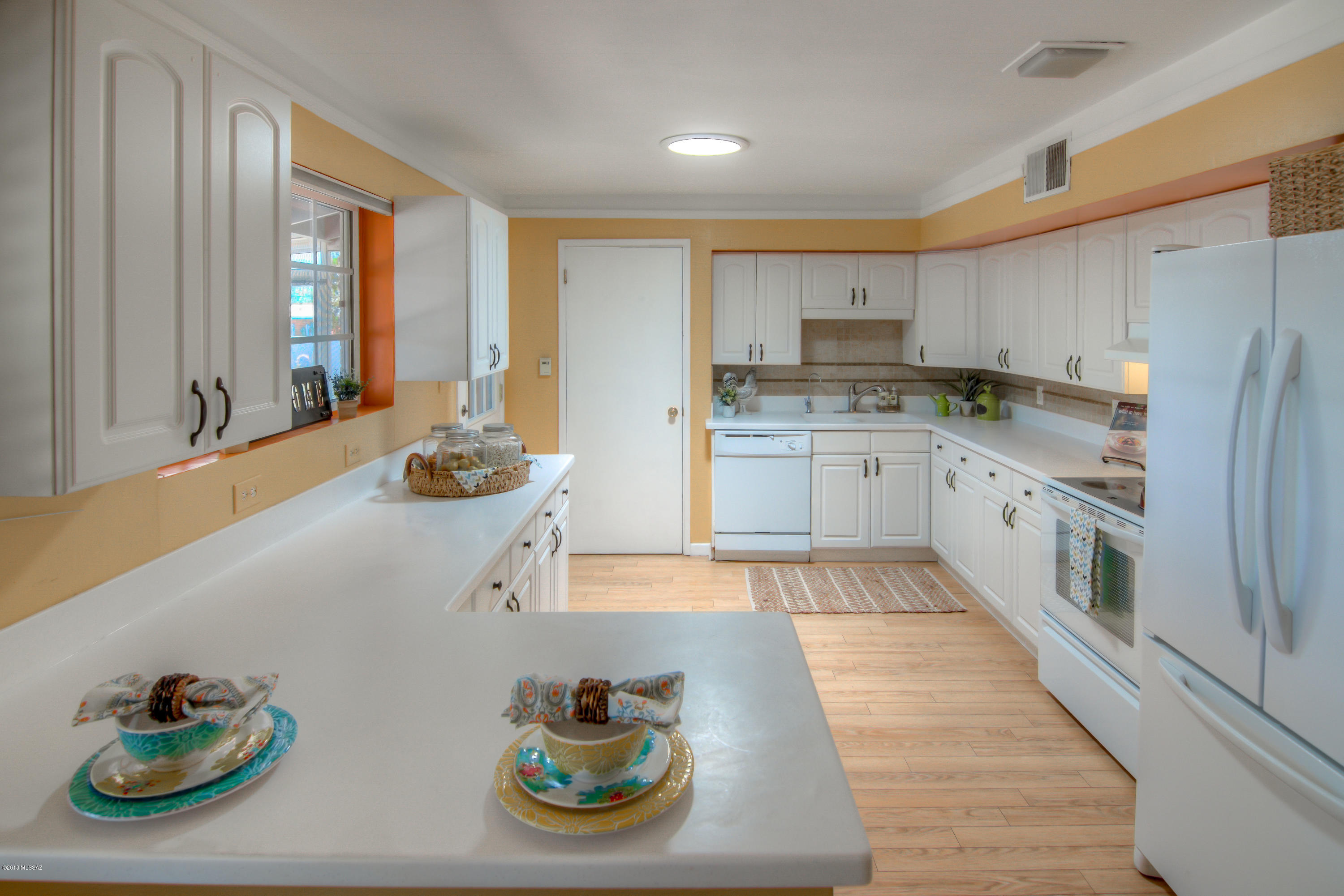 PRICE REDUCED- mid century, midwest vibe, tri level home in a quiet central neighborhood w/815sf guest suite--perfect for multi generation living! Main floor has living room w/dramatic fireplace, dining area &  fully equipped kitchen with white cabinets, Corian counters & fridge. Lower level guest suite has a kitchenette (fridge, dishwasher, sink/disposal, stove) 1BR/1BA & rec room! Washer, dryer, water softener, reverse osmosis & 2 solar powered attic exhaust fans also included!  Extensive upgrades include: new roof, real red oak hardwood floors upstairs, dual pane windows & plantation shutters, baths remodeled by Re-Bath, ceiling fans & solar tubes throughout, 2 screened porches & 2 storage sheds in the back yard! Close to schools, neighborhood park, shops, restaurants, medical & DM AFB!