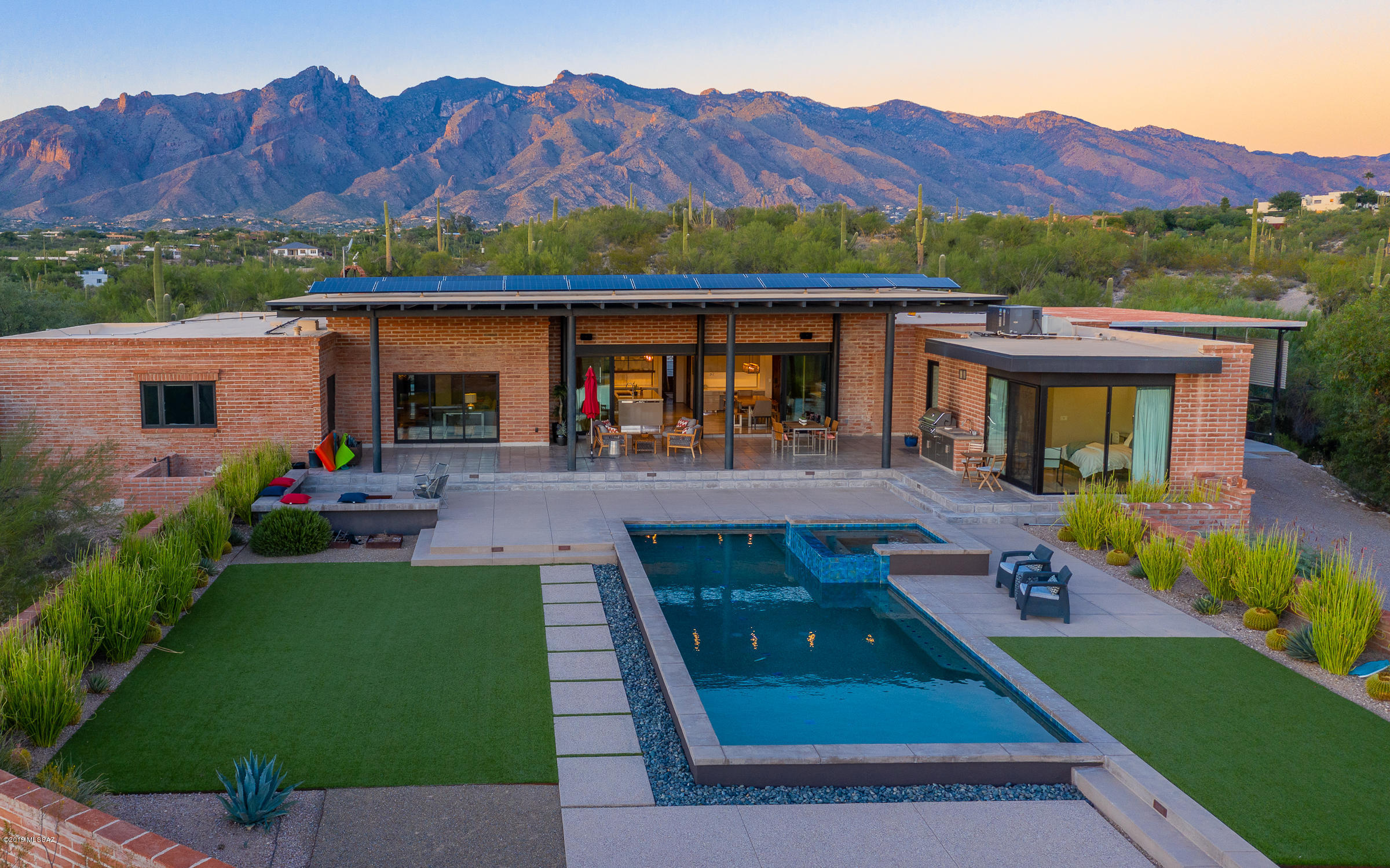 Come see this one-of-a-kind home at the top of Camino Antonio. The timeless texture of Sasabe burnt adobe, the clean lines of cold-rolled steel, and the presence of Douglas Fir beams are magic. The gorgeous Mick De Giulio Kitchen is a thing to behold; with SieMatic cabinetry, Jenn-Air & Sub-Zero appliances, and Taj Mahal Quartzite countertops. Enjoy indoor/outdoor living with stacking glass doors from the kitchen and family room to the oversized covered patio. Plus you get all the views -- City lights, A Mountain, distant mountains, sunsets and the Catalinas -- from your private 2.27 acres, adjacent to properties on larger lots. 'White Oak' marble tile flooring, wood and carpet in the right places. High ceilings, solid doors throughout. All the bathrooms are gorgeous, too. Tons of storage The kitchen in this home is truly the heart of the home! The designer is internationally known and has been featured in Architectural Digest showcasing his design for the Coppola family's Italian Palazzo and House Beautiful showcasing his Kitchen of the Year. This is one of the finest kitchens you will find in Tucson in a house at this price point.