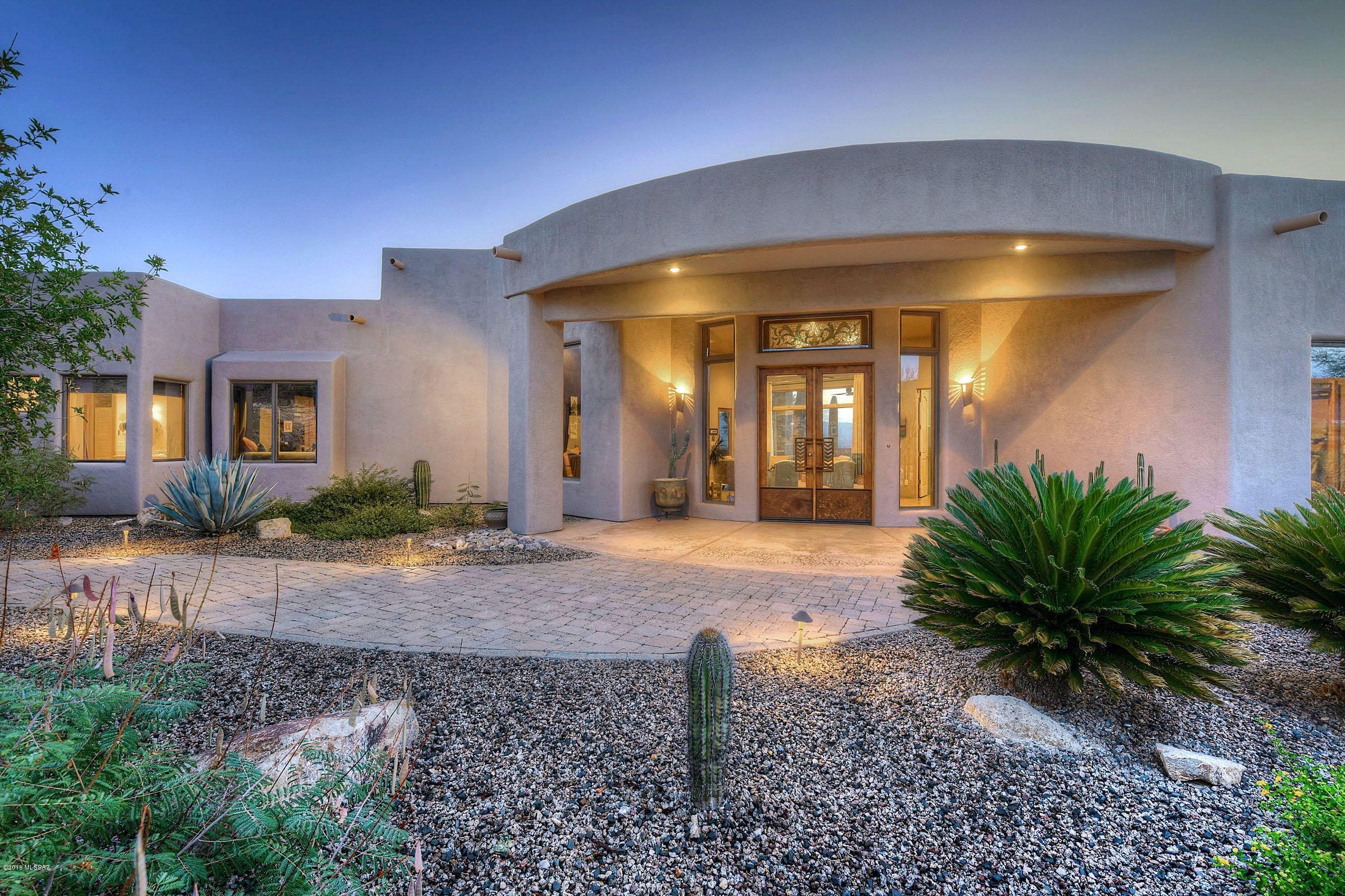 Climb the stately aggregate drive to this awe inspiring, meticulously crafted contemporary masterpiece w/gorgeous city & mtn views built w/eco-friendly structurally insulated panels & exquisitely designed down to the smallest detail.  The spectacular open floorplan has dramatic soaring ceilings, beautifully polished concrete floors, multiple fireplaces, gorgeous custom cabinets, chiseled granite counters, top-of-the-line SS appliances & humidity controlled walk-in wine storage that will make you the envy of your entertaining friends.   The massive covered patio w/outdoor kitchen & sparkling negative edge pool/spa will keep your guests mesmerized by the fabulous views and comfortable like you're inside.  On a 3-AC, saguaro studded hilltop lot and only 6 miles and 10 minutes from downtown.