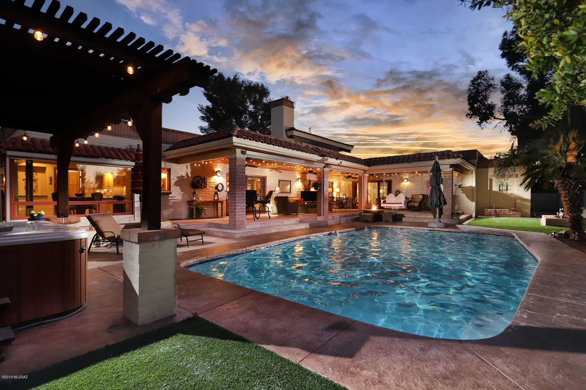 Seller will accept or counter offers between $799,990 and $824,999. Golfers paradise!!Omni Tucson National property. Home is a charming territorial designed sprawling ranch which has been exquisitely remodeled with custom handcrafted woodwork throughout, living room with 24' ceiling. The home features a secluded master retreat with expansive ensuite; guests have two separate suite areas. Entertain year round outdoor living with extensive covered patios and a separate BBQ area and large custom-built in island bar providing a central gathering spot for gatherings large or small. Renovated Laundry room works for catering needs. Close to shops, dining & movie theatre.