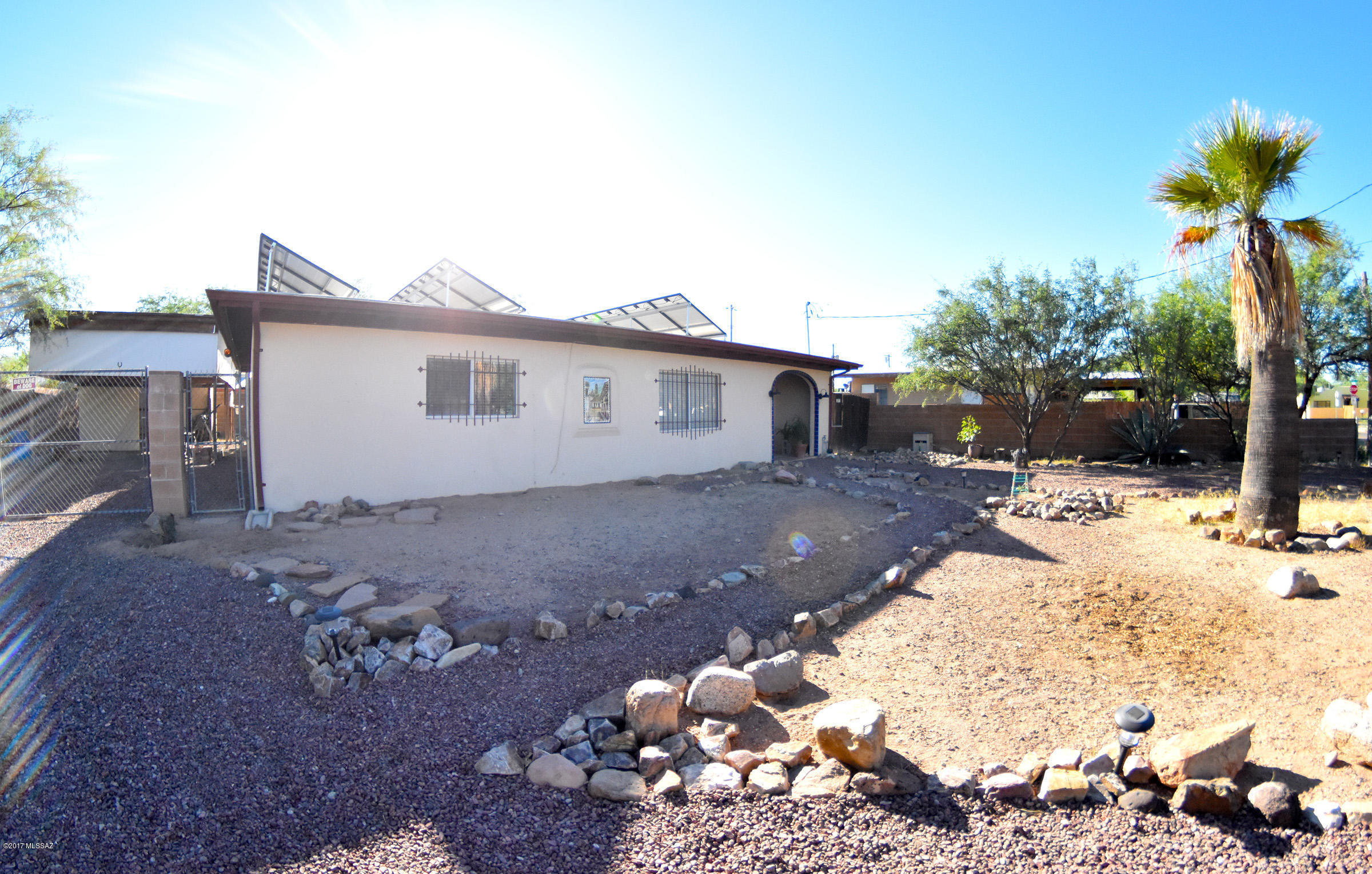 Come view this beautiful home with many upgrades! This 2 bed, 1 bath with 1,271 square feet includes a very large den and an office space. Enjoy new flooring, the spacious kitchen, and an updated bathroom. The property also includes solar panels that are owned FREE AND CLEAR! Because of the panels, the owners haven’t had to pay for a single electric bill since moving in! Along with a beautiful home, the property also has a rainwater collector and a huge workshop in the backyard. Because this property is on about a quarter of an acre, there’s plenty of space for all of your toys such as RV’s, boats, etc. This southwest style home has great features that make it one of a kind. Don’t miss out!