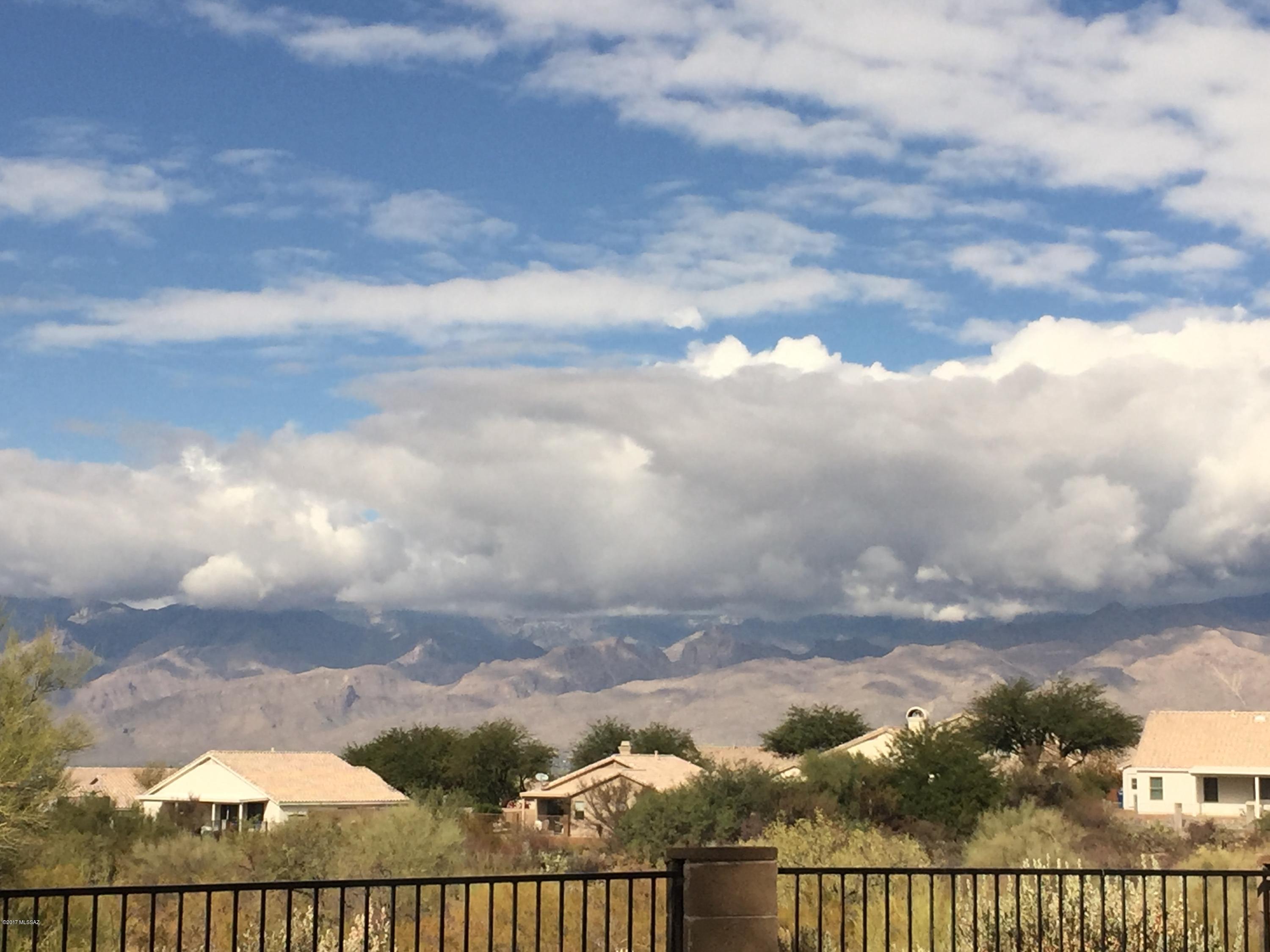 Panoramic views of Catalinas and Rincons. Terrific open floorplan with great room featuring beehive fireplace and views of mountains through windows. Split bedroom plan with two guest rooms and bathroom at one end and master bedroom bathroom at other end.  Lots of storage areas throughout this wonderful home. Kitchen features Corian countertops, double undermounted sinks, gorgeous tile accents, plenty of counter space and custom cabinets including extra counter space and 4 large drawers for storage.  Small eat-in area that looks out on lush front yard desert vegetation perfect for the morning coffee or tea. Stainless Steel appliances including a 5 burner gas stove.  Lots of great views from this wonderful home.