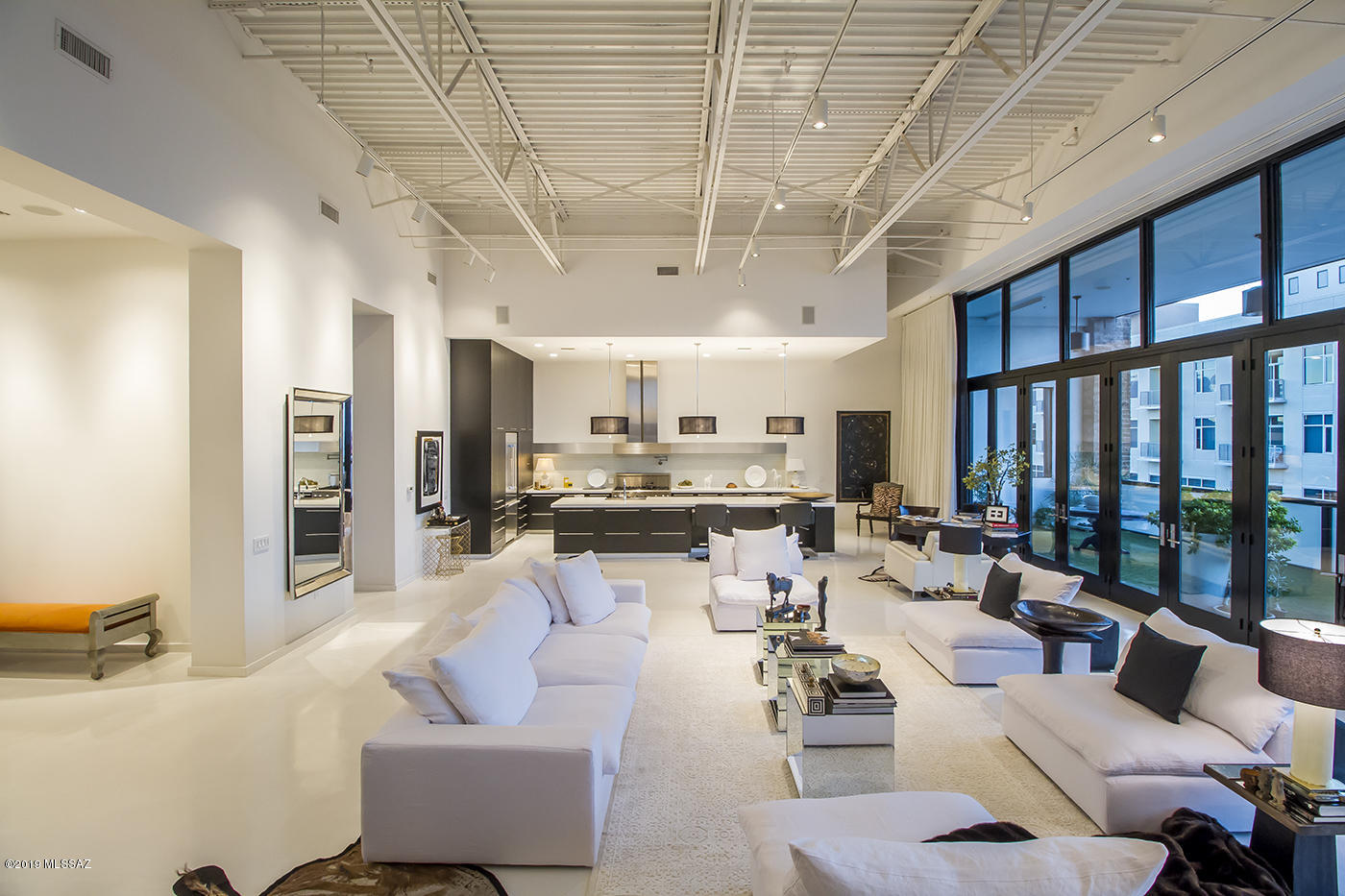 A true loft condominium with floor to ceiling north facing panoramic windows & 20Ft ceilings, The only of its kind in our downtown, this condominium  offer all the amenities that allows to live in exclusive comfort in the heart of Downtown Tucson. White concrete floors, surround sound system, steam room, open chef kitchen with beautiful counter tops and top of the line cabinets. Spacious balcony to enjoy and to entertain. Parking in private gated parking garage.