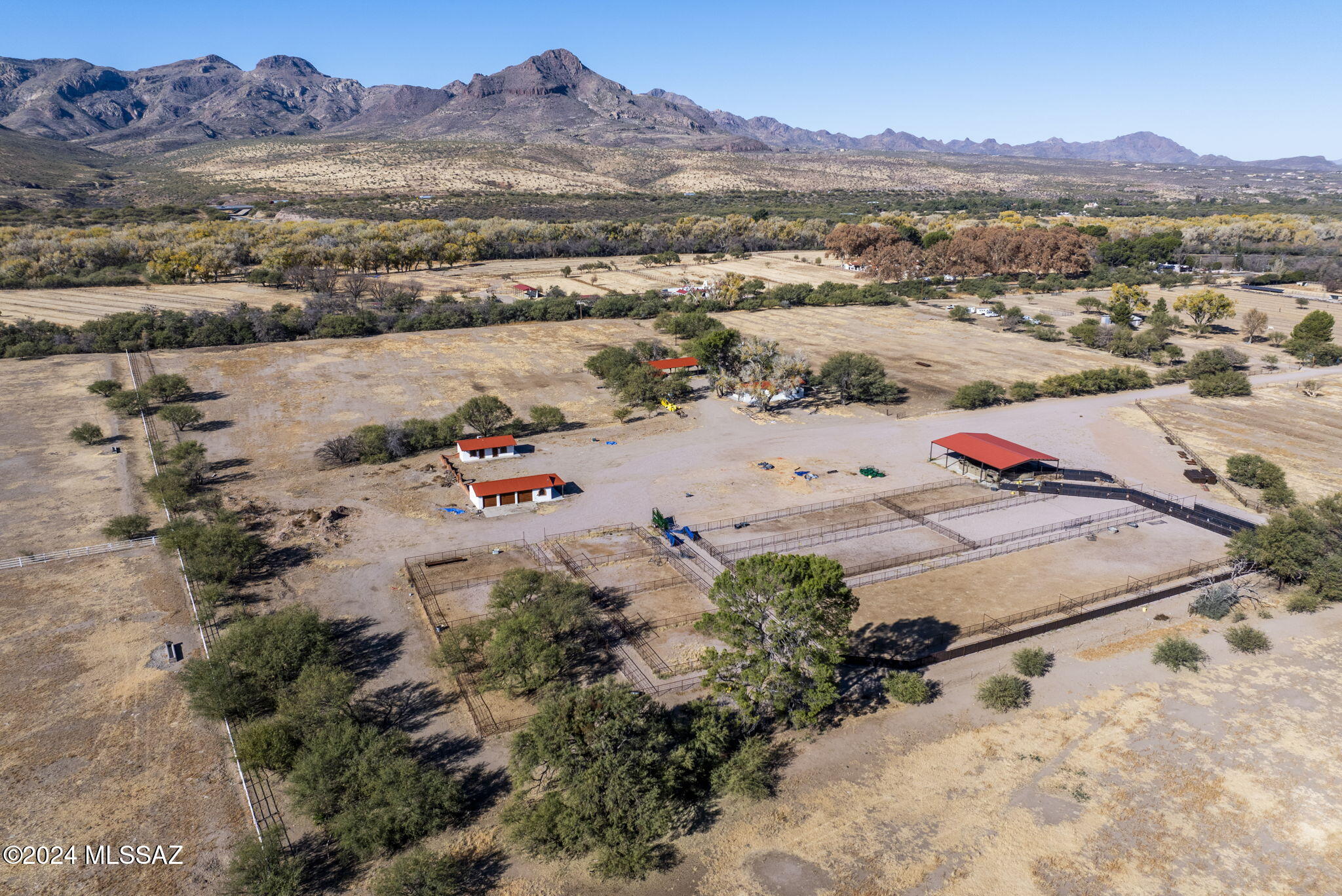 This unique property offers approximately 47 acres of land with grandfathered irrigation water rights, providing the opportunity to cultivate crops or maintain livestock. The land is equipped with essential agricultural infrastructure, including pens, cattle shoots, and a large, versatile adobe outbuilding/shop, ideal for various uses, additional equipment or a shop. The main residence is a remodeled 1,822-square-foot building, complemented by a guest casita with two bedrooms, a full bath, and a kitchen/laundry room. Although the residential structures are served by a 35-gallon exempt well, the property also includes an irrigation well, which, when operational, could pump up to 500 gallons per minute. The grandfathered water rights allow for the pumping of 73 acre-feet of water annually, making it perfect for agricultural pursuits. With its close proximity to Interstate 19, offering easy access to Tucson and Nogales, this property combines a rural lifestyle with convenient access to urban amenities, making it an ideal location for those seeking a self-sustaining operation or a peaceful retreat in the Santa Cruz Valley.