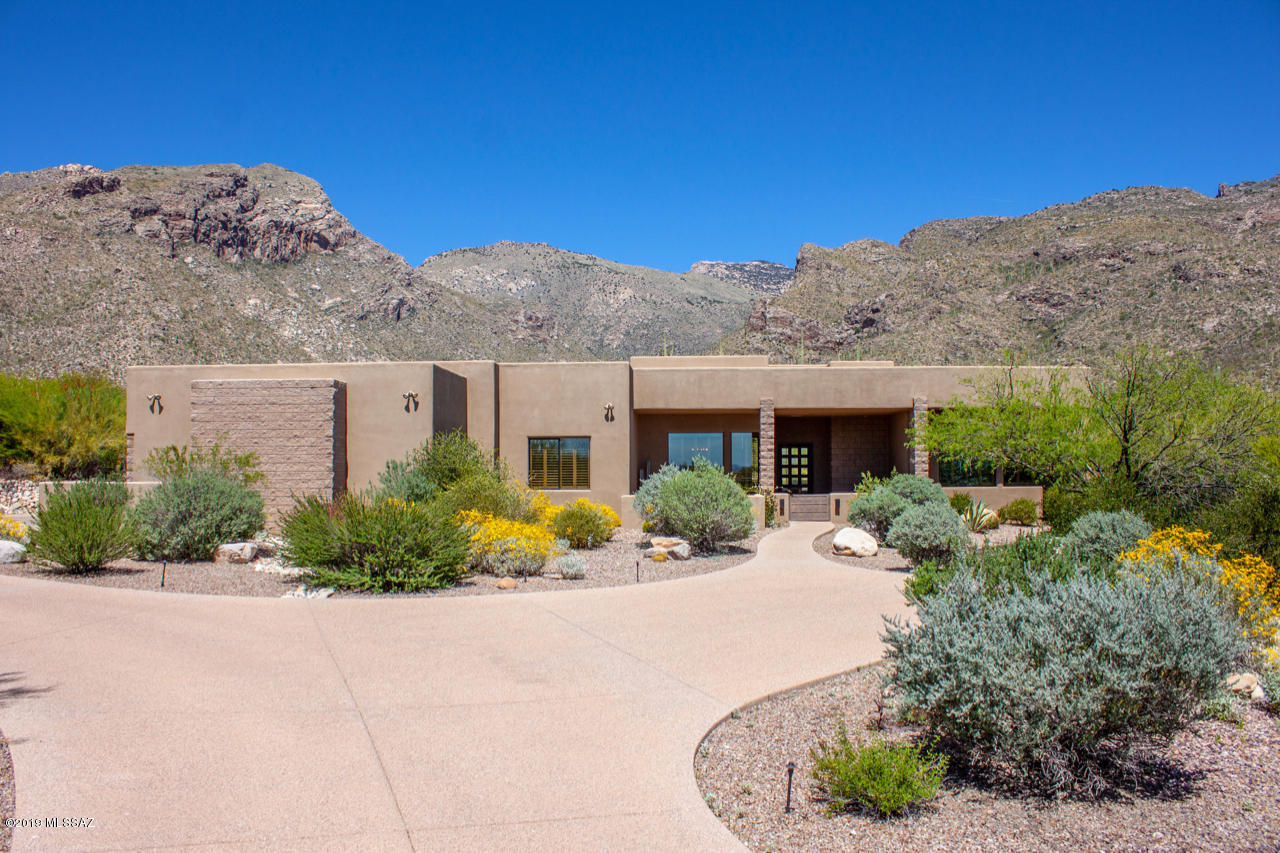 Beautiful 5 BR Hm or 4 BR + Office located in the prestigious Gated Community of Pima Canyon Estates on a premium lot w/ captivating Mt Views! Split BR Plan; Master Suite & BR#5/Office on one end of hm; BR#2 & BR#3 w/ Jack & Jill Full Bathroom on other end; BR#4 Suite w/ Private Bathroom in another area of hm; Powder Rm convenient for guests near entry; Handscraped Solid Hardwood-Oak Flooring thru out; Ceramic Tile-Bathrooms & Laundry; Laundry Rm w/ newer Maytag W/DR, & lots of cabinets/closet & sink; LRm w/ dramatic Mt Views; Lg Formal Dining Rm; Lg Granite Island in Kitchen; Viking Appliances including Dbl Oven, Warming Drawer, Gas Range, D/W, & Subzero Refrig.; Walk-in Pantry, Built-in Desk;  Heated/Cooled Exercise Rm off Oversized 3 Car Garage; Wireless Pool/Spa/Waterfall Controls...