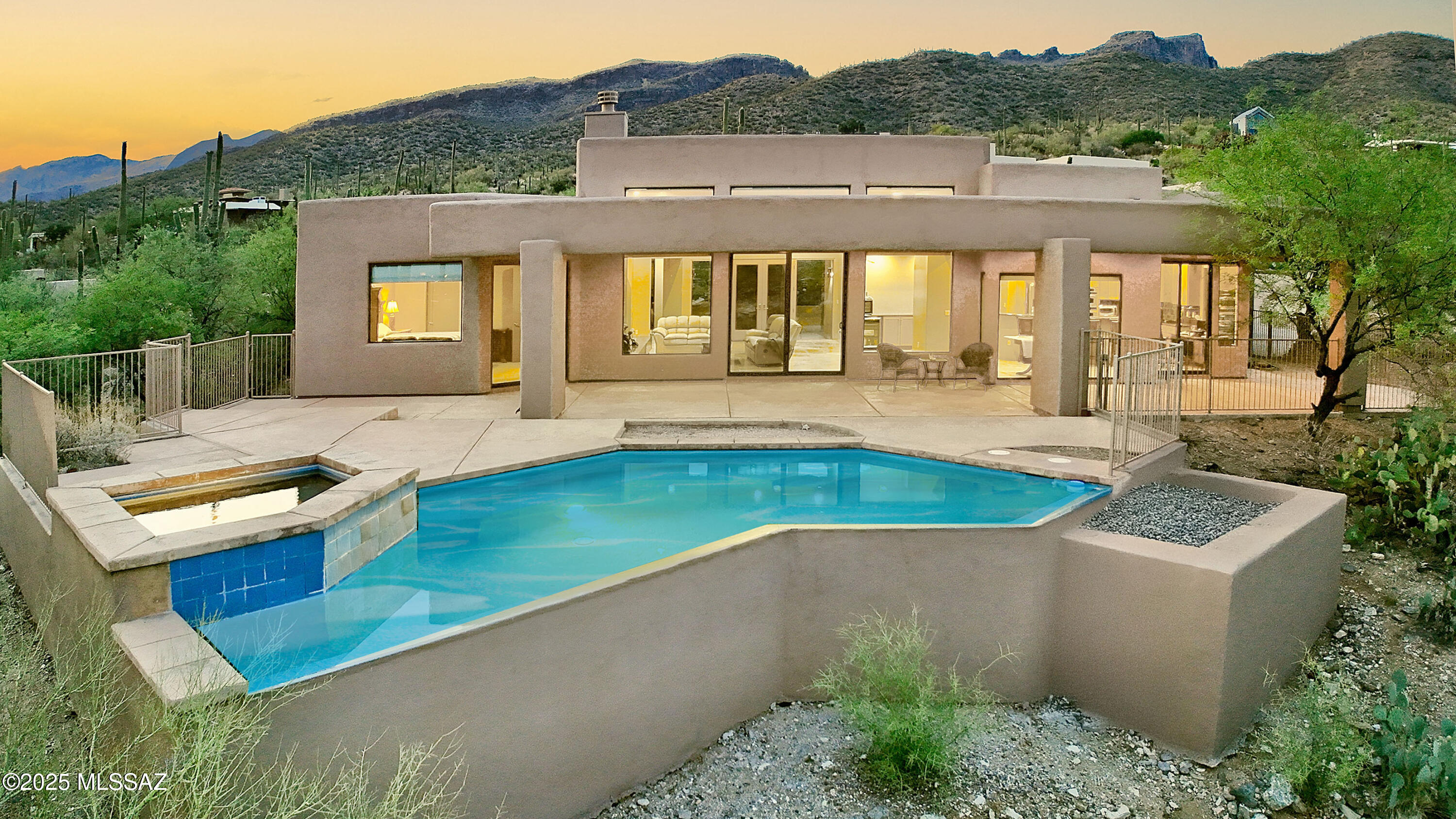 Stunning soft contemporary designed by award-winning architect, Kevin Howard, known for creating a serene indoor/outdoor atmosphere. Situated high on a ridge overlooking city, mountain, sunrise & sunset views in the prestigious guard-gated golf course community of Sabino Springs. Elegant glass entry doors invite you into this exceptional home with over 2564 sq. ft., encompassing an exquisite Great Room w/ high ceilings, dramatic contemporary fireplace, walls-of-windows to capture incredible views, beautiful Travertine tile floors, gourmet island kitchen w/ custom designed KraftMaid cabinets, granite countertops, stainless steel GE Profile appliances, gas stovetop, coffee & wine bar w/mini fridge, pantry, lovely breakfast area, 2 bedrooms+ executive study w/ beautiful built-in.. continued cabinets or a 3rd bedroom (split plan), 3 baths, including primary suite with sitting area, luxurious bath with double vanities, jetted tub, separate shower, Kohler fixtures throughout, large walk-in closet, laundry room and oversized 2-car garage. Enjoy the resort-like backyard with extended covered patio, pool, spa and views, views, views!