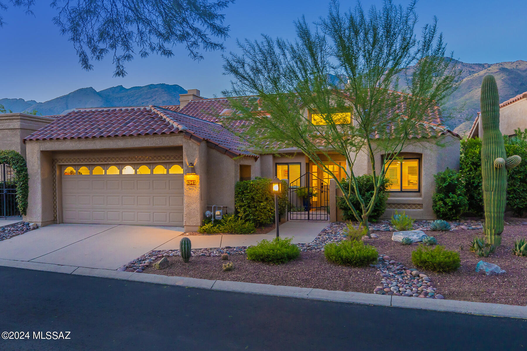 Beautifully remodeled Ventana Canyon Golf Villa with stunning Catalina Mountain views from the north-facing patio and gas fire pit. This bright, open home features vaulted ceilings, new flooring, designer paint, and fully updated baths with custom cabinetry and granite countertops. The modern kitchen offers new cabinets, appliances, and a reconfigured layout with added windows for natural light. Upgraded windows and doors throughout, with new blinds and shutters. Exterior improvements include remodeled patios, irrigation, new lighting, and planting beds. Recent HVAC and hot water heater provide peace of mind. Steps away from the community pool and just a short walk to the Club/Lodge for golf, tennis, pickleball, swimming, and dining. HOA covers landscaping for easy, lock-and-go living in this resort-style villa.
