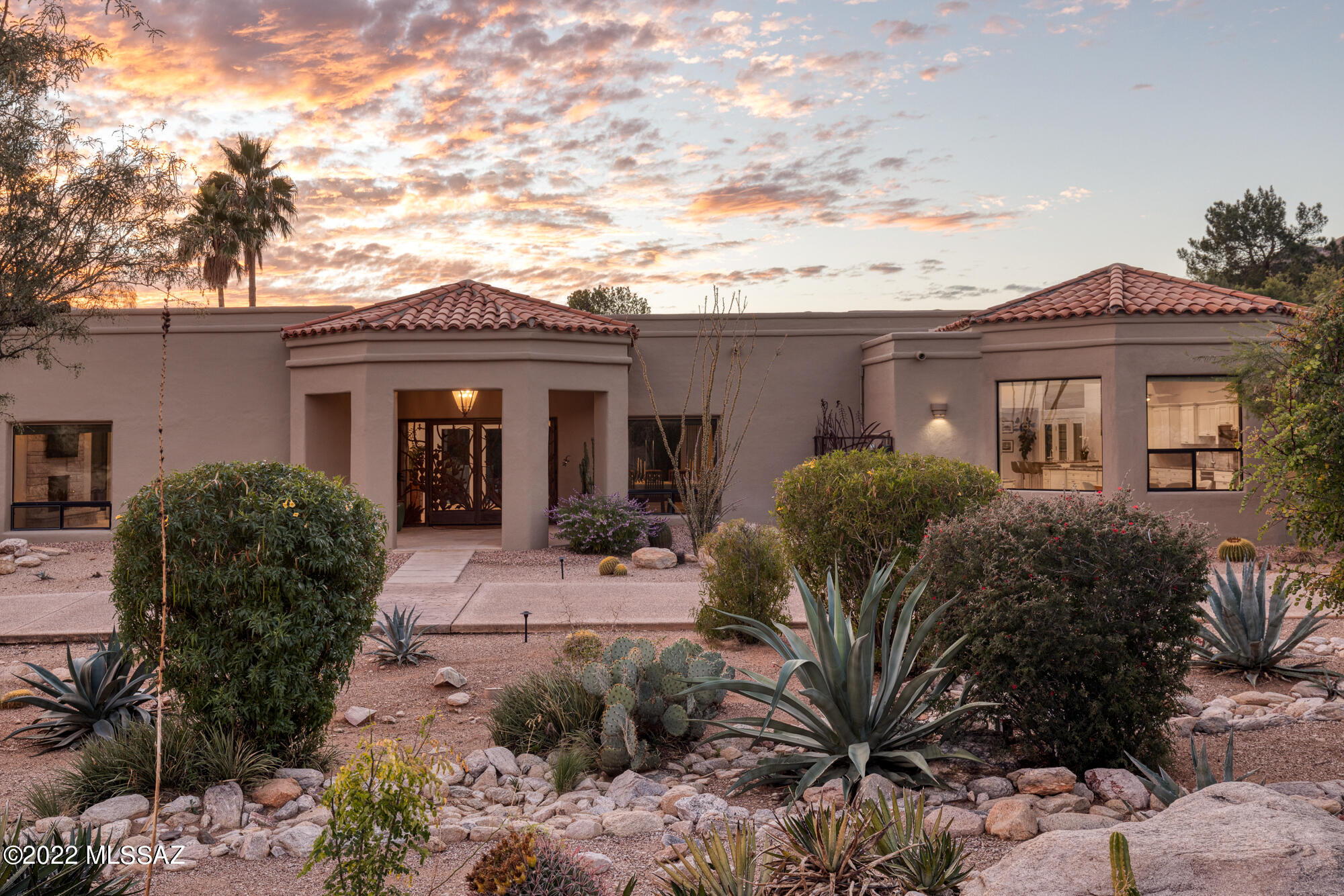 Beautifully remodeled contemporary home in Skyline Country Club Estates. The single level main home (5,304 Sq Ft) features 3 spacious bedrooms in addition to the primary bedroom, reminiscent of a luxurious resort suite that encompasses two walk-in closets, walk-in shower, and a primary bathroom larger than many bedrooms. The attached guesthouse (782 Sq Ft) is adjacent to the 3rd car garage and has a private entrance leading to a comfortable and private space perfect for a multi-generational family, guests, or separate living quarters. The guesthouse is fully equipped with a kitchen, living space, separate bedroom, and bathroom. Words and pictures alone cannot capture the beauty and function of this expansive property. The home exhibits a time-consuming renovation, combined with meticulous care, thoughtful details, and an abundance of desirable features and upgrades. Upgrades include new travertine floors, marble primary bathroom, several new energy efficient windows & doors, garage doors, water heaters, HVAC, interior & exterior paint, appliances, and finishes.

Sitting just off the 14th hole, on a private 1.2 acre lot with breathtaking panoramic views of the Santa Catalina Mountains, the home also features an updated cook's kitchen with a large island and pantry, private backyard with solar heated pool and outdoor kitchen, three fireplaces, large 3 car garage w/ storage & Tesla charging station, vast multi-use turf grass outdoor space, and spacious yet comfortable guest spaces highlight this Skyline Country Club Estates home.

Incredible lifestyle with Skyline Country Club within walking distance. Private golf, tennis, pool, health club family activities, and restaurants are available as part of a membership to Skyline CC. The lifestyle presents an incredible opportunity to either take advantage of the proximity of the Country Club amenities or relax or entertain at home with your friends and family.