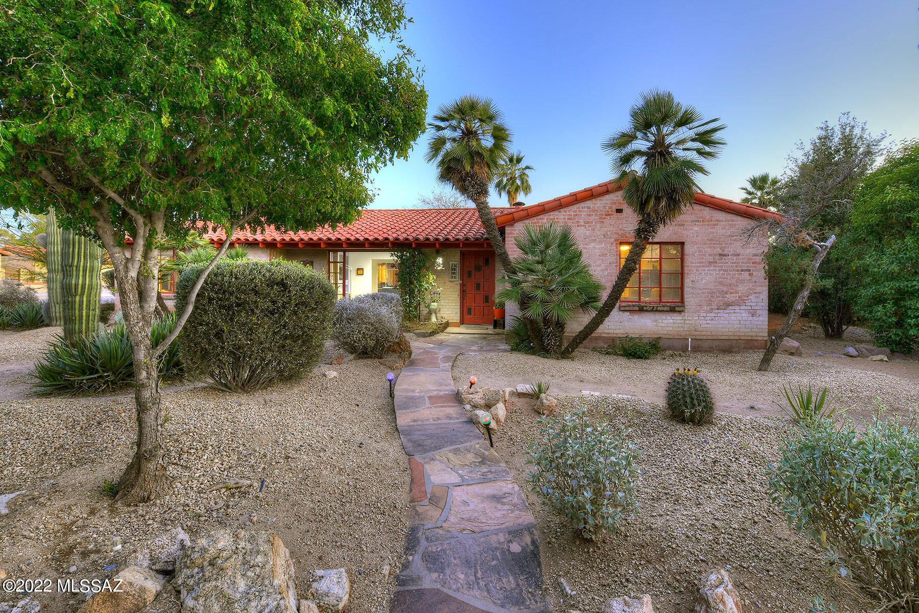 TRULY CHARMING Spanish style home with modern, whimsical interior decor!  Large corner lot in Historic Catalina Vista. Fabulous landscaping features stately saguaros, cacti, low care shrubs/trees & a vegetable garden.  Separately fenced swimming pool. Stunning back courtyard perfect for entertaining year round.
Great Room has mountain views, tiled wood burning fplc and lighted blt-in shelving. Dining area opens to a chef's kitchen: gas cooktop, butcher block counter,
built in table, tons of cabinets + work space! Primary  suite has an office/den with blt in shelving, opening to a spacious bedroom w/wood burning stove, re done bath: walk in shower, jetted tub & double vanity.
Two good size bedrooms both are adjacent to a bath.
Delightful casita has a kitchen, bedroom & bath.
A TREASURE Tile and polished concrete flooring except one bedroom has carpet. Large storage room has a utility sink.  Garage has been used as an art studio.  Shelving may need to be removed to park vehicles  in the garage.  The covered patio area has been used as an art area,
but could be turned into a lovely patio.  Taxes are based on owner occupied historic status.  Casita has recently been used as a successful Air BnB.