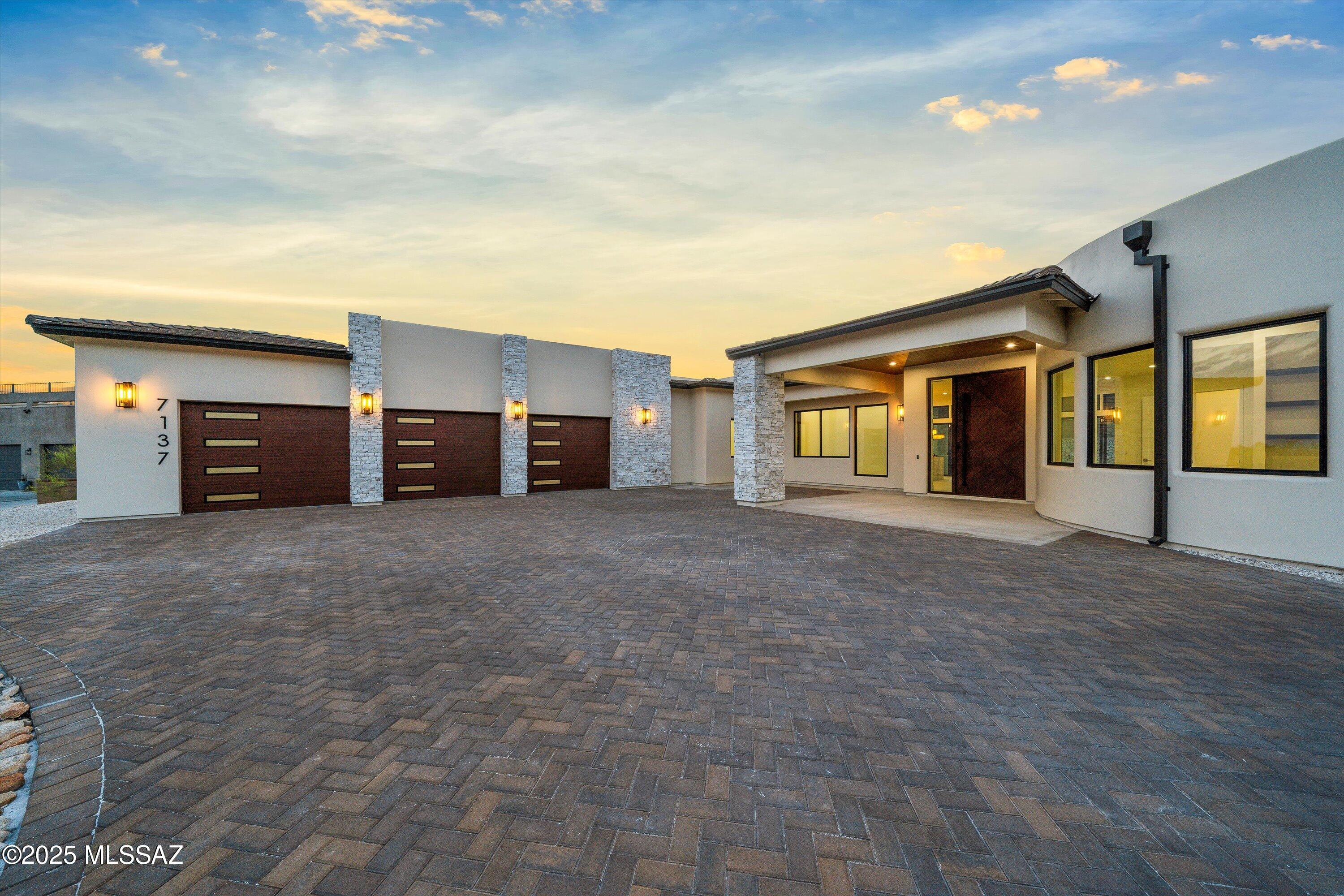 Experience ultimate luxury in this 2025 new construction home where modern elegance and thoughtful design come together seamlessly. Upon arrival, the striking contemporary architecture sets the stage for an unparalleled living experience. Bathed in natural light, this energy-efficient residence showcases premium finishes chosen with meticulous care to define contemporary luxury. The open-concept living space features a stunning gourmet kitchen with custom cabinetry, Taj Mahal countertops, an oversized waterfall island, top-of-the-line appliances, and an expansive built in hidden pantry it all serves as a culinary heaven where style meets functionality. Wall-to-wall sliders usher you to a resort-style backyard designed for exceptional indoor/outdoor living. Off the living area is an office space with custom storage cabinets soaring picture windows overlooking city & mountain views. The primary's wing also offers a space that can serve various purposes from a home gym, media room or a second home office, the primary suite is a serene retreat with soaking tub, oversized shower, beautiful lighting fixtures, and a spacious custom walk-in closet. Step into the backyard, an entertainer's paradise designed for relaxation and gatherings. This is your exclusive luxury resort offering complete privacy. A heated pool featuring a baja shelf, swim-up bar, sunken lounge with a firepit and ample sitting space. Minutes away from restaurants, golfing, parks and much more.