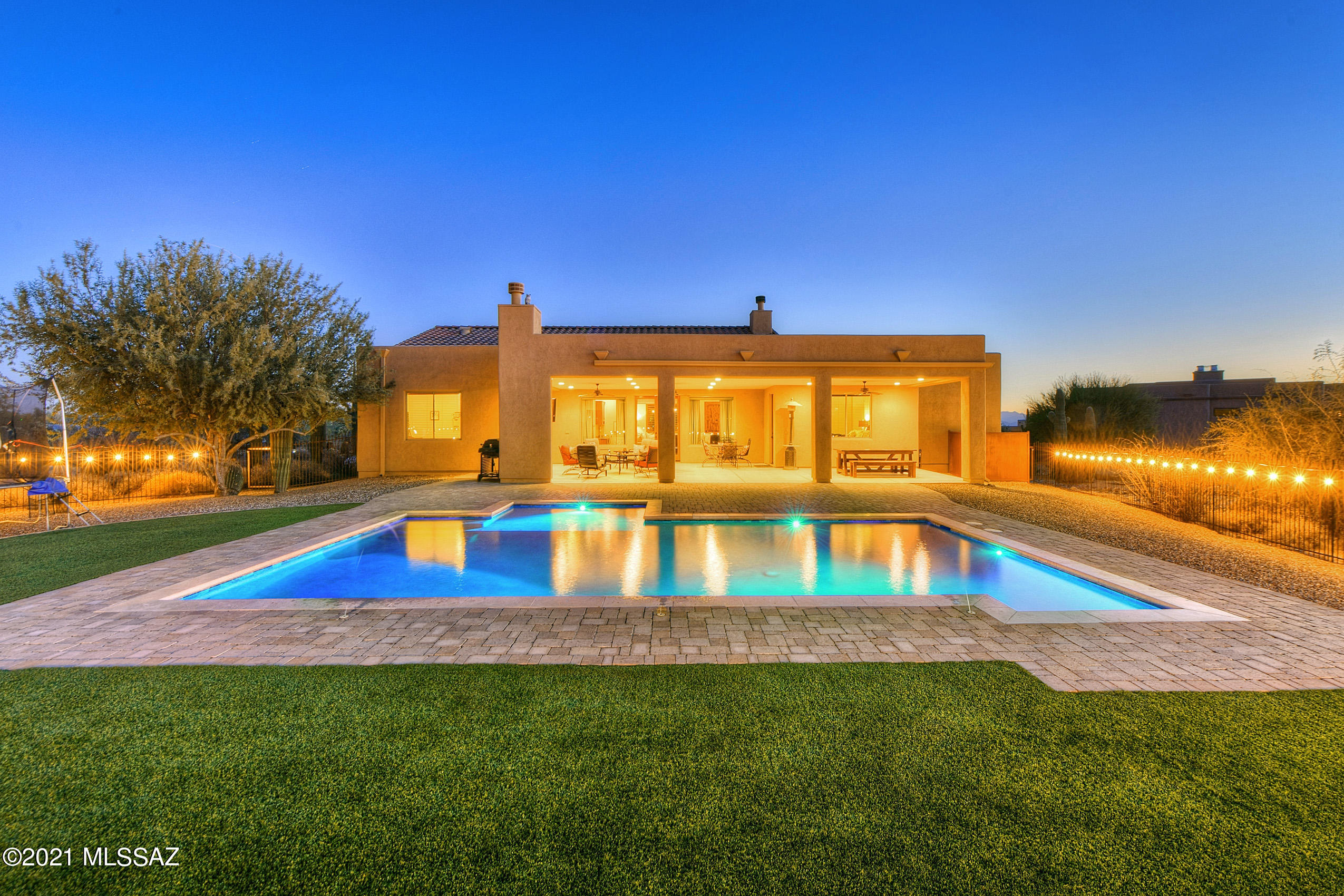 Seller shall entertain/counter offers from $775k-$800k. Private setting but close to city amenities. Custom 4 bedroom, 3 bath,  3,072 sqft. home sits on over 1.02 acres lot backs to open space dotted with Majestic saguaros, beautiful sunset and mountain views of the Tortolita Mountains. Constructed in 2015 in classic Southwest Contemporary style, the main residence features elegant design features unique to Desert Mountain living, masonry gated courtyard with custom steel double doors, travertine floors through out, two gas fireplaces (great room & patio),  8 foot Alder interior doors, over-sized four car garage. The home features a balanced free flowing design from the great room featuring a 13 foot ceiling height with wood beams, spacious laundry room with custom wallet cabinets, granite counter top with sink, with two flexible rooms off of the great room,  Double French door leads to the outdoor living space offering a relaxing vibe including outdoor fireplace, extended patio with pavers leads to pebble-tec pool with fountain spray. Everywhere, windows and glass doors allow bursts of natural light to soften and envelop the spaces and connect them with the outdoors. The meticulously designed chefs' kitchen features built-in Decor stainless steel appliances, 6 burner gas cooktop, massive island with sink, granite slab counters, walk-in pantry, and stunning knotty walnut custom cabinetry with crown molding. A gracious owner's suite with a huge master bath, two executive height vanities, walk in shower with travertine tile surrounds, and garden tub.  Secondary bedrooms share a jack n Jill bath, fourth bedroom near a powder room with a shower. The current owners have been loving stewards that created an inviting retreat for entertaining and celebrations.