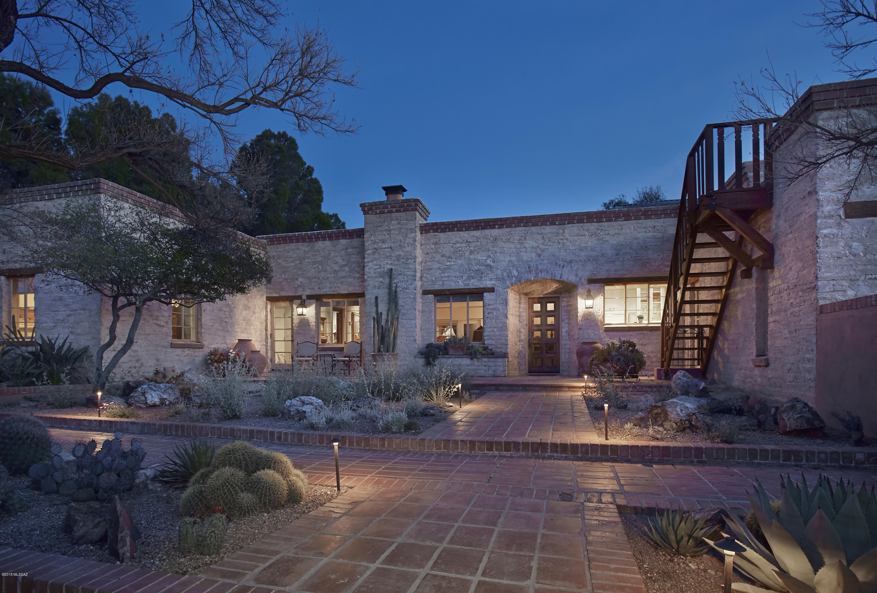 Truly a once in a lifetime opportunity to own one of the finest Joesler Estates ever to be offered in Tucson! This stunning property sits on a private gated 5.2acre ridgetop lot in the heart of the ''Old Foothills'' with 360 views & has been landscaped to perfection to create a spectacular low maintenance botanical garden. The original home built in 1943 features 3 bedrms, 2 private offices, original doors & windows, concrete floors, an open & bright kitchen w/Viking & Sub Zero appliances & views of finger rock. The lavish master suite wing features an updated bathrm, walk in closet, office & sitting area. The newer guest house features 1 bedrm,1 bath + living rm & kitchenette. The backyard overlooking the city has tinkling fountains, an outdoor living room w/fireplace & sparkling lap pool